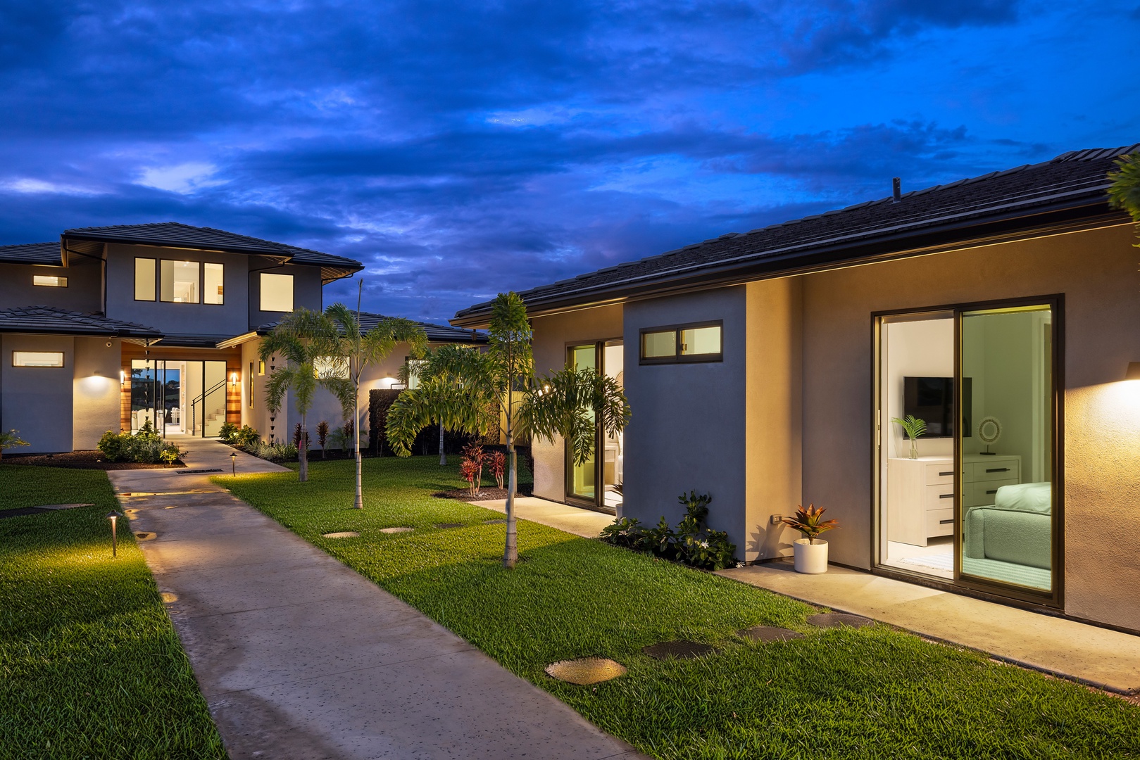 Kamuela Vacation Rentals, 6BD Mauna Lani Lux Golf Estate (6) at One Ocean - The path home lights up at dusk, the house warm and low against the darkening sky.