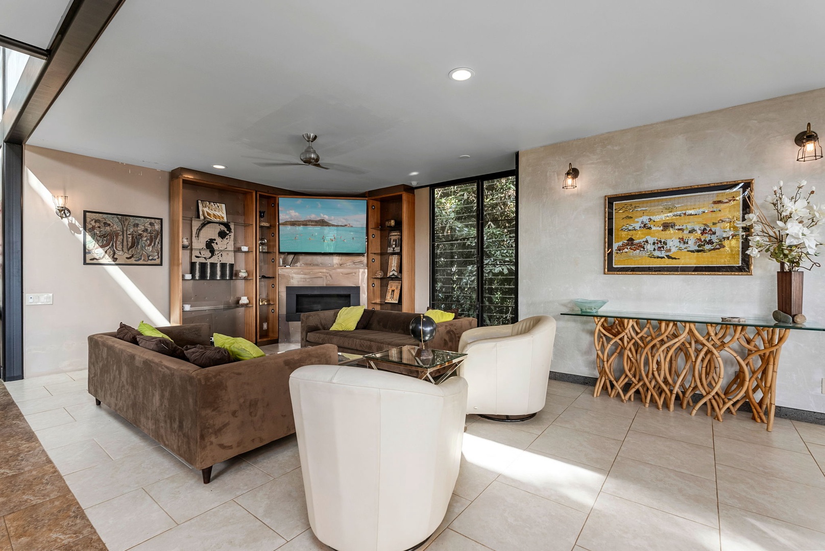Honolulu Vacation Rentals, Tantalus Glass House (3 BD) - Sink into plush seating surrounded by curated art and warm wood accents in this sophisticated living space designed for relaxation.