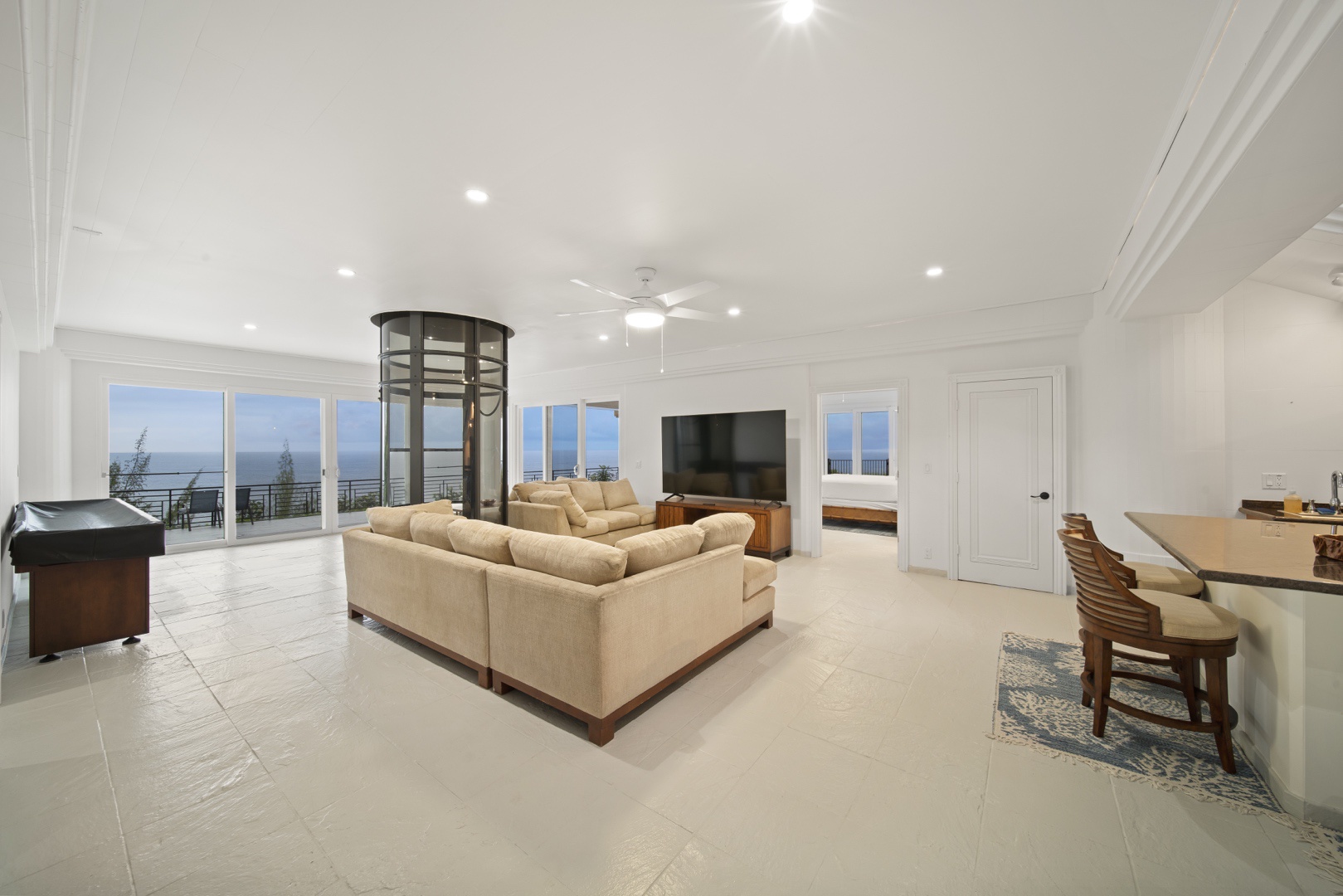 Ninole Vacation Rentals, Waterfalling Estate - First floor great room with wraparound deck, ocean views & kitchenette.