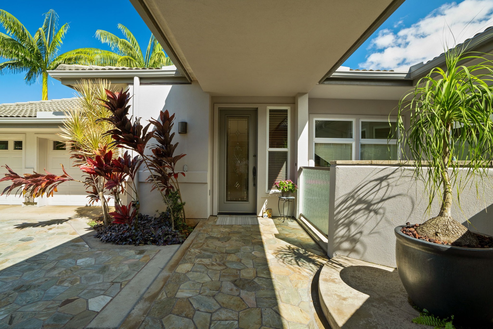 Princeville Vacation Rentals, Kaiulani #8 - Come home through a stone entry courtyard lined with potted plants.