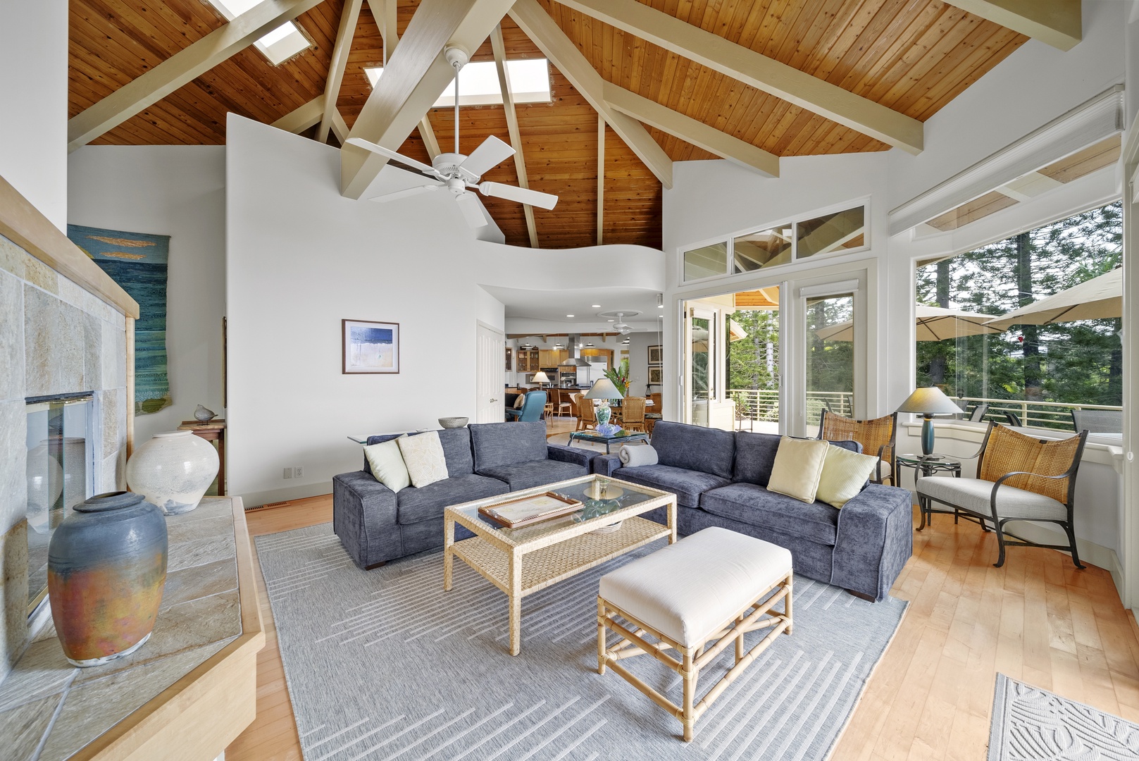 Haleiwa Vacation Rentals, Ka Hale Hau'oli - Relax in your expansive living room with soaring wood-beam ceilings, cozy sectional seating, and floor-to-ceiling windows framing forest views.