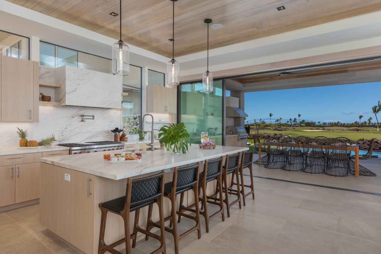 Waimea Vacation Rentals, 5BD Mauna Lani Lux Golf Estate (4) at One Ocean - This beautifully designed kitchen features a large central island with stylish bar stools, providing the perfect spot for morning coffee or casual dining.