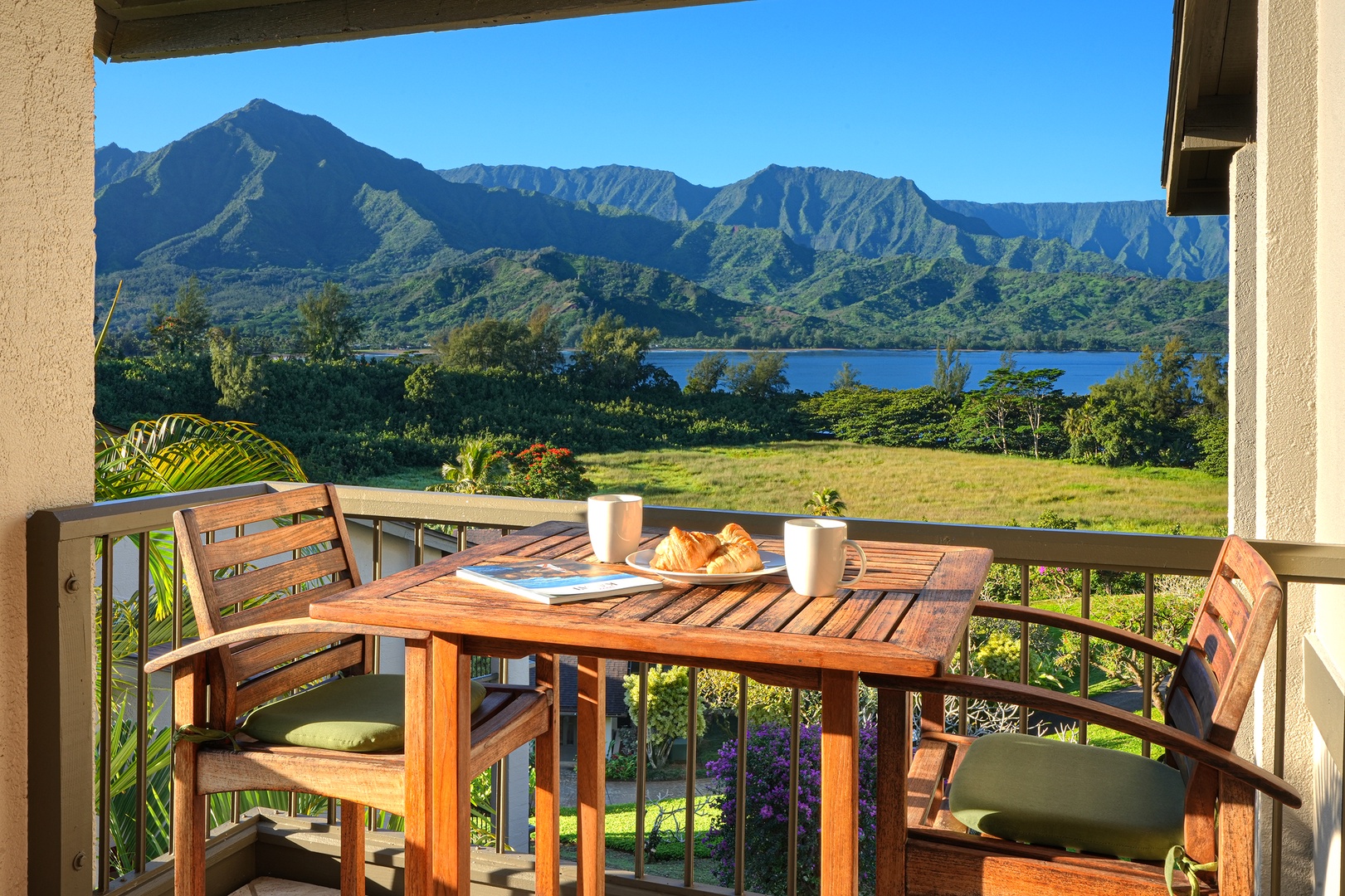 Princeville Vacation Rentals, Hanalei Bay Resort 4301/2/3 - Dine outdoors while enjoying incredible views of the lush mountains and ocean from the lanai. – Perfect spot for a peaceful morning coffee or sunset dinner.