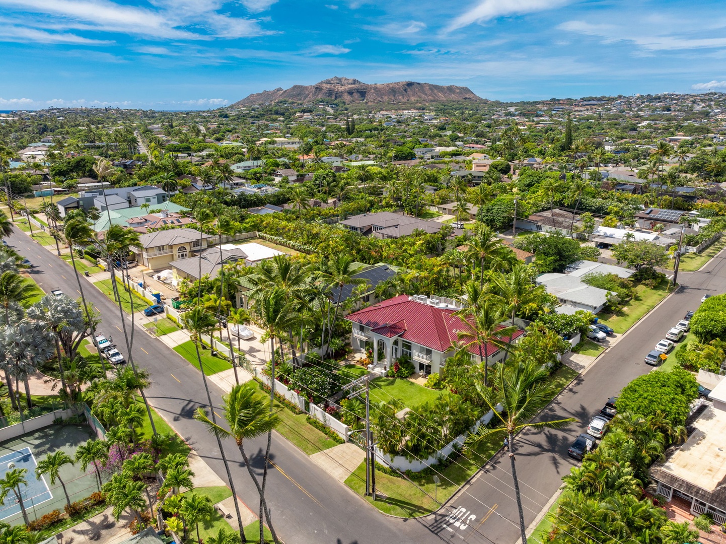 Honolulu Vacation Rentals, Kahala Oasis - Aerial view of the neighborhood with a scenic backdrop of mountains, highlighting the serene surroundings.