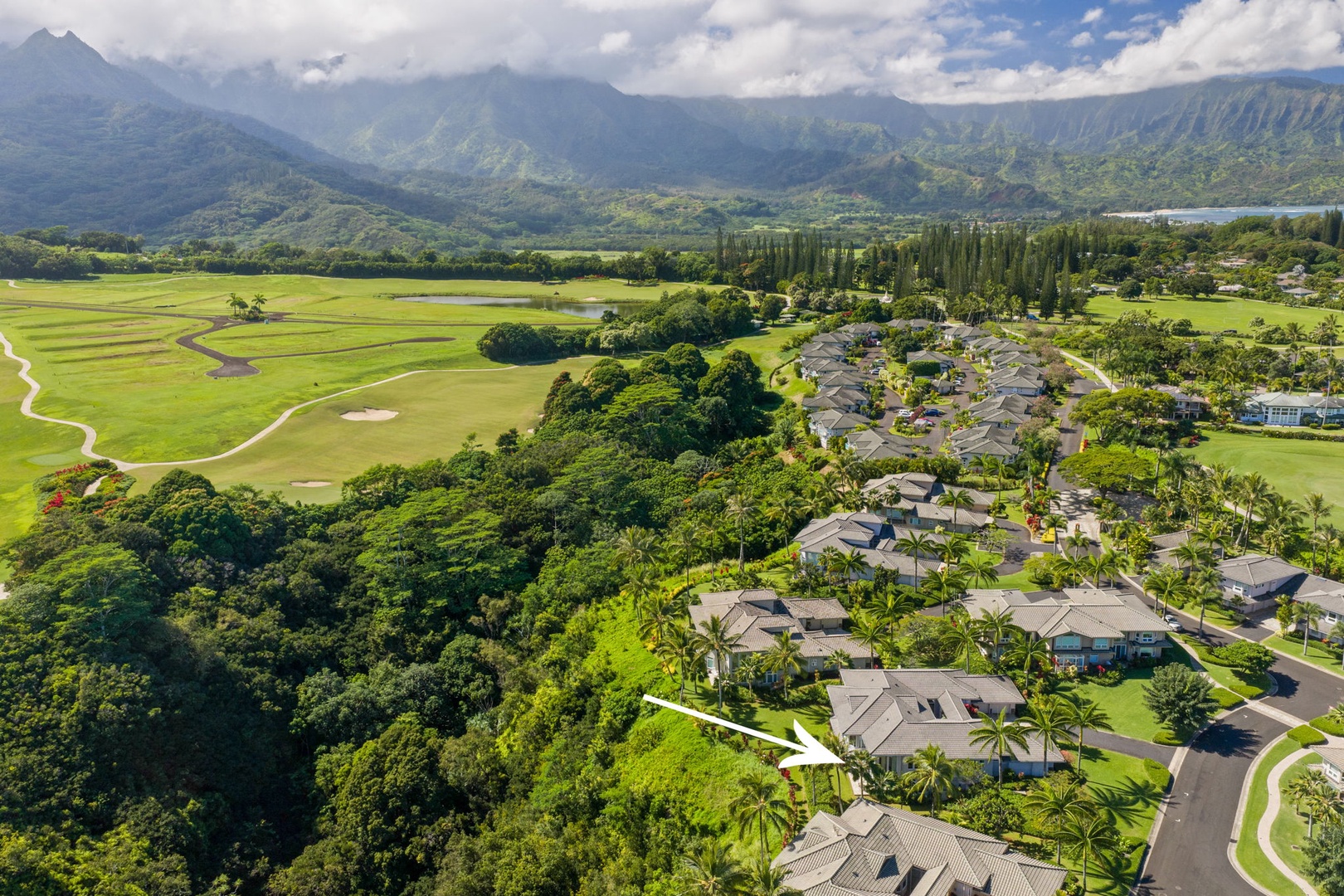 Princeville Vacation Rentals, Kaiulani #8 - The arrow marks the townhome, with the mountains lined up on the horizon.