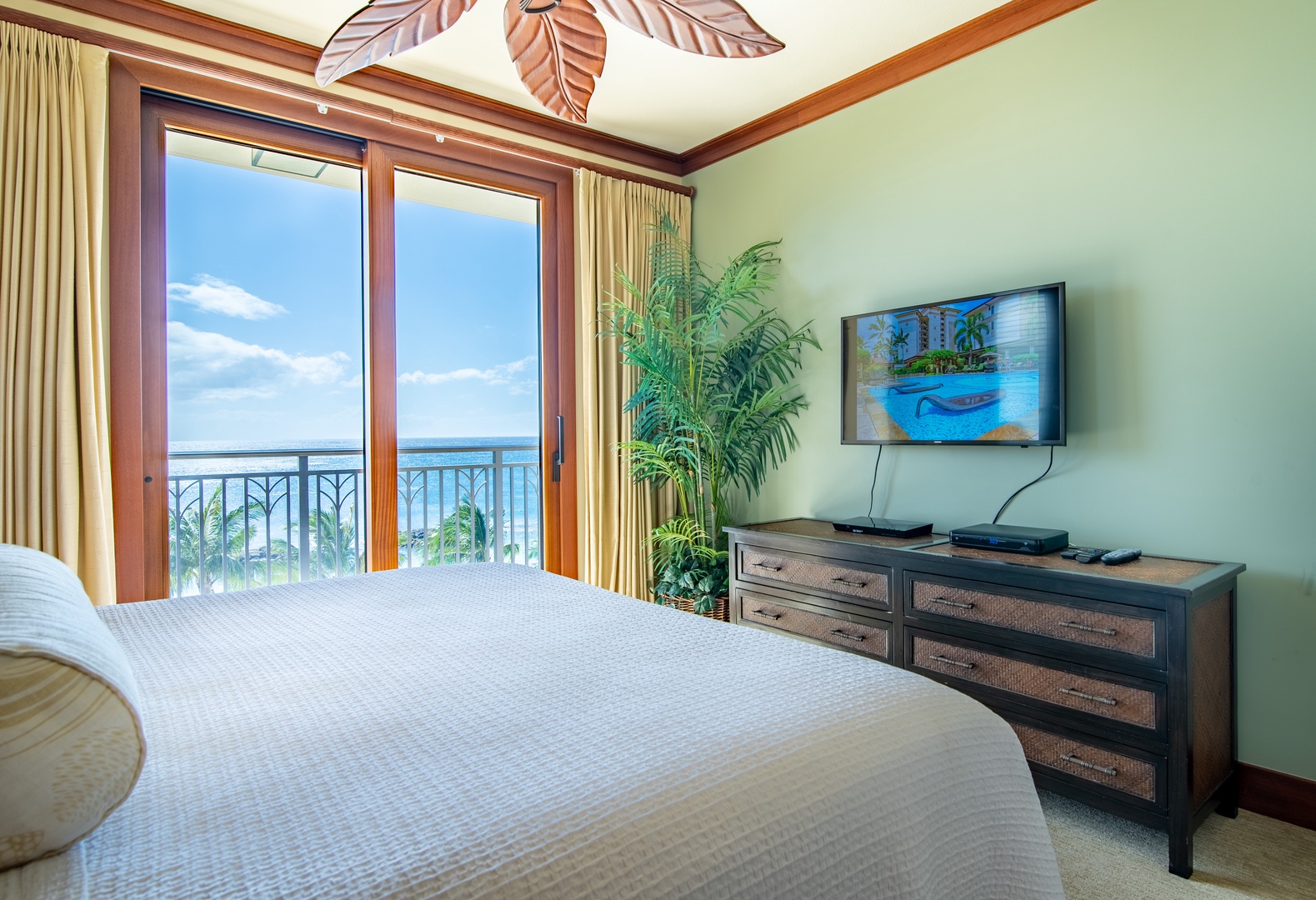 Kapolei Vacation Rentals, Ko Olina Beach Villas B609 - The primary guest bedroom with TV and access to the lanai.