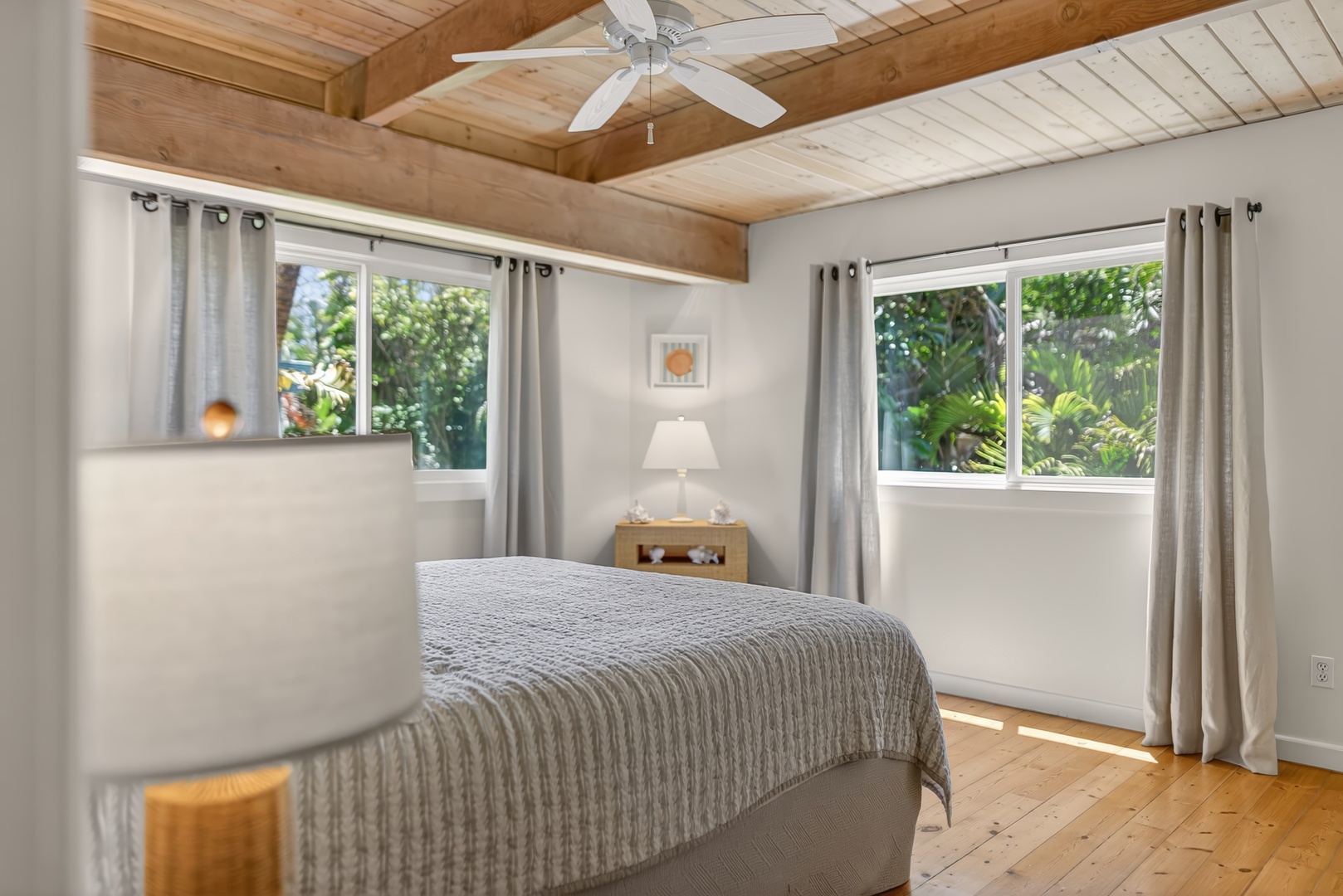 Haleiwa Vacation Rentals, Sunset Beach Hideaway - Relax in the spacious guest room with Cal king bed, breezy windows and vaulted wood ceilings.