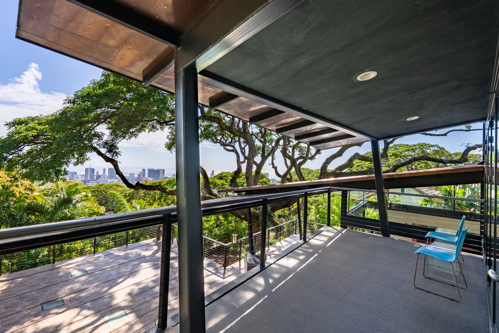 Honolulu Vacation Rentals, Tantalus Glass House (3 BD) - Relax on your private covered lanai with stunning city skyline views through tropical trees, perfect for morning coffee or evening unwinding.