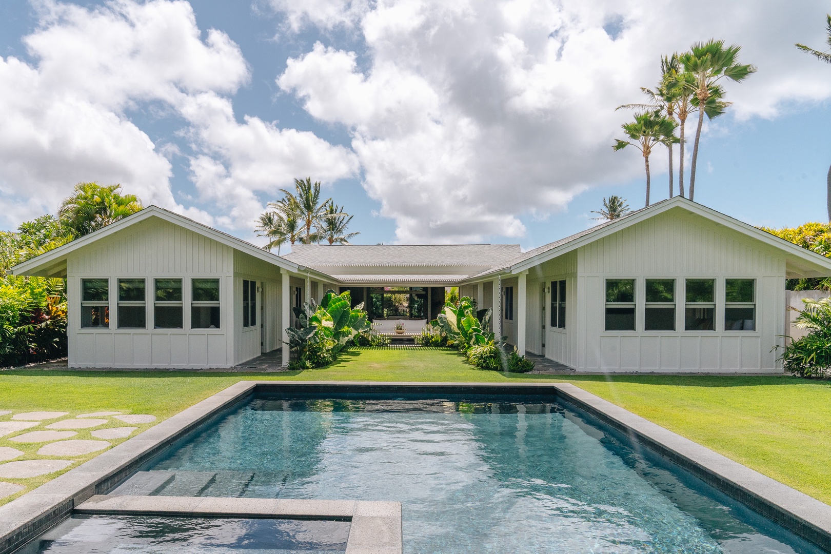 Honolulu Vacation Rentals, Surfside Bungalow** - Unwind by the private pool, surrounded by lush landscaping and swaying palms.