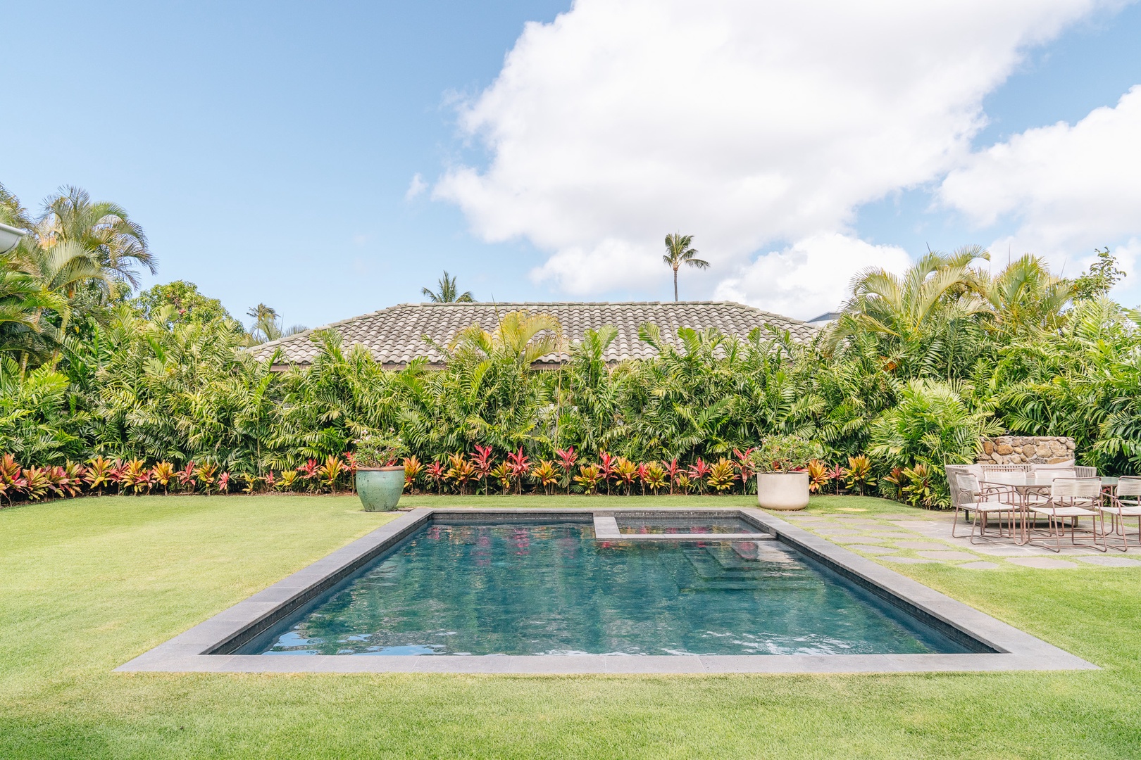 Honolulu Vacation Rentals, Surfside Bungalow** - The private pool is surrounded by lush tropical landscaping and a spacious lawn for relaxing afternoons outdoors.