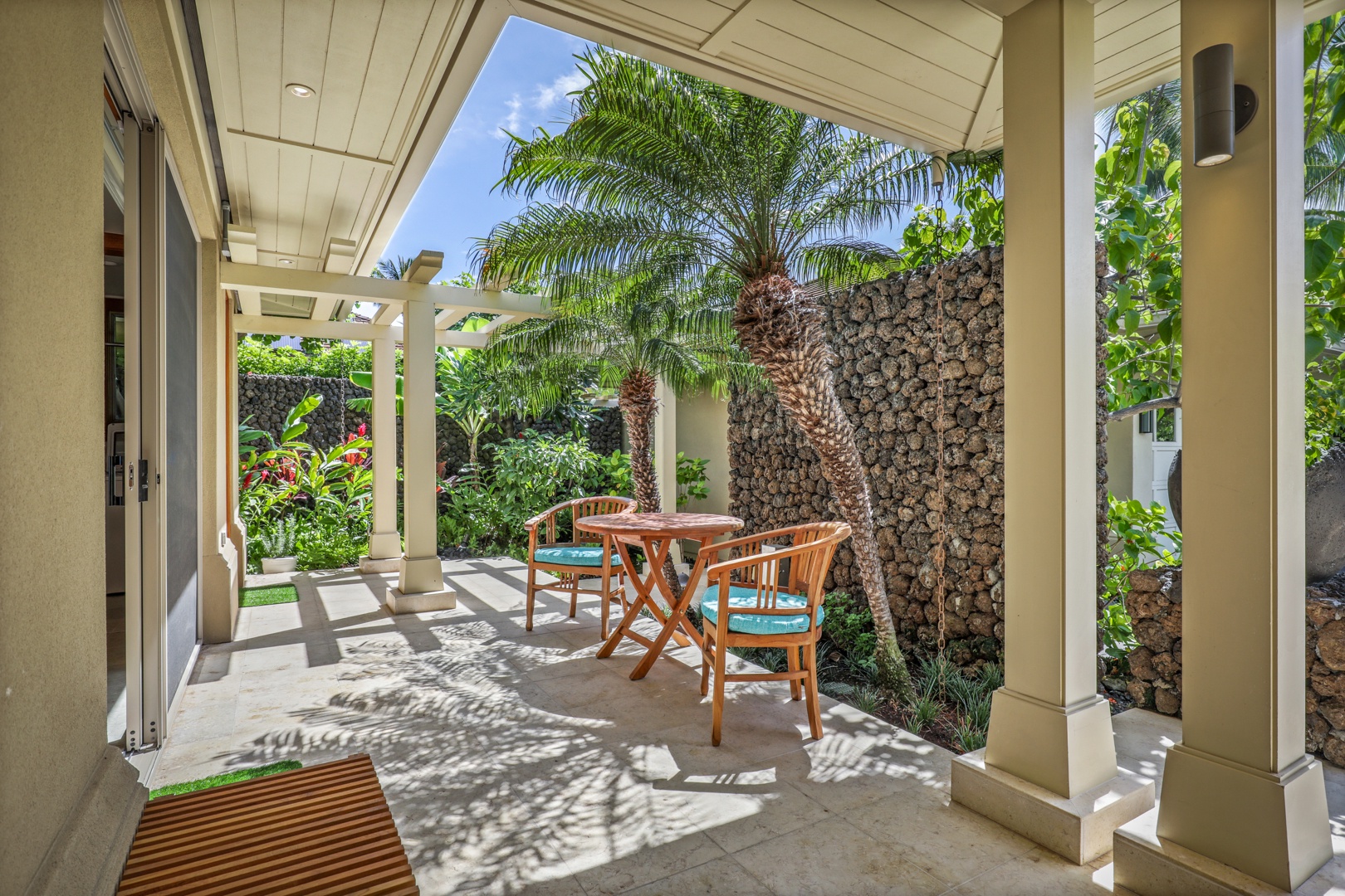 Kailua Kona Vacation Rentals, 4BD Hainoa Estate (122) at Hualalai Resort - Exterior kitchen cafe table seating surrounded by tropical foliage.