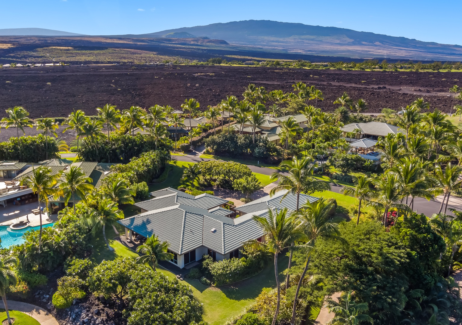 Kamuela Vacation Rentals, Champion Ridge Oasis - Clear skies and sunshine view emphasizing the home’s grand layout and tranquil atmosphere.