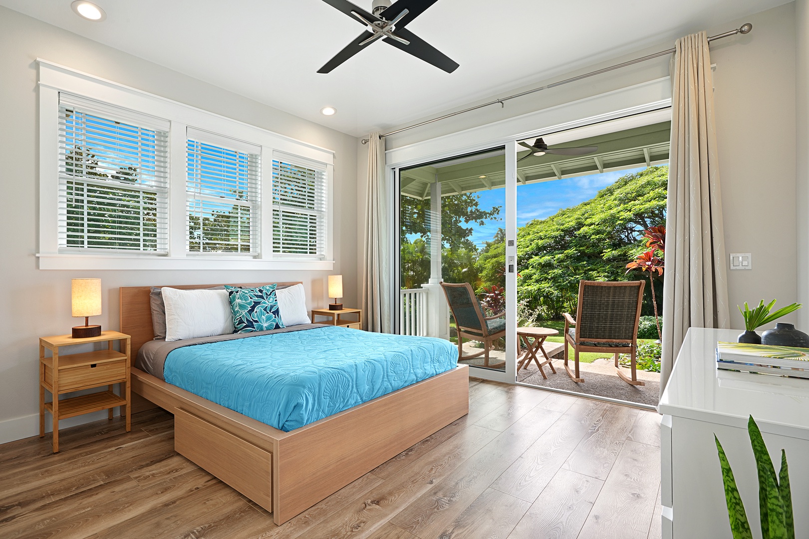 Koloa Vacation Rentals, JC Surf House - Primary bedroom downstairs with AC, ensuite bathroom, and lanai