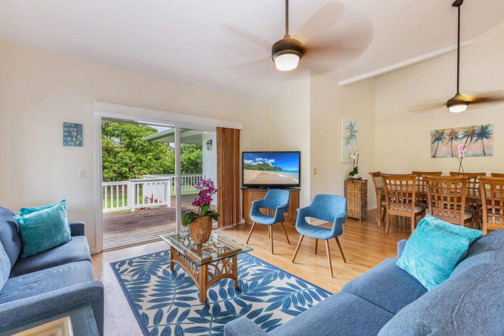 Princeville Vacation Rentals, Hale Cassia - The living area with a flatscreen TV features a seamless indoor-outdoor living with easy access to the lanai