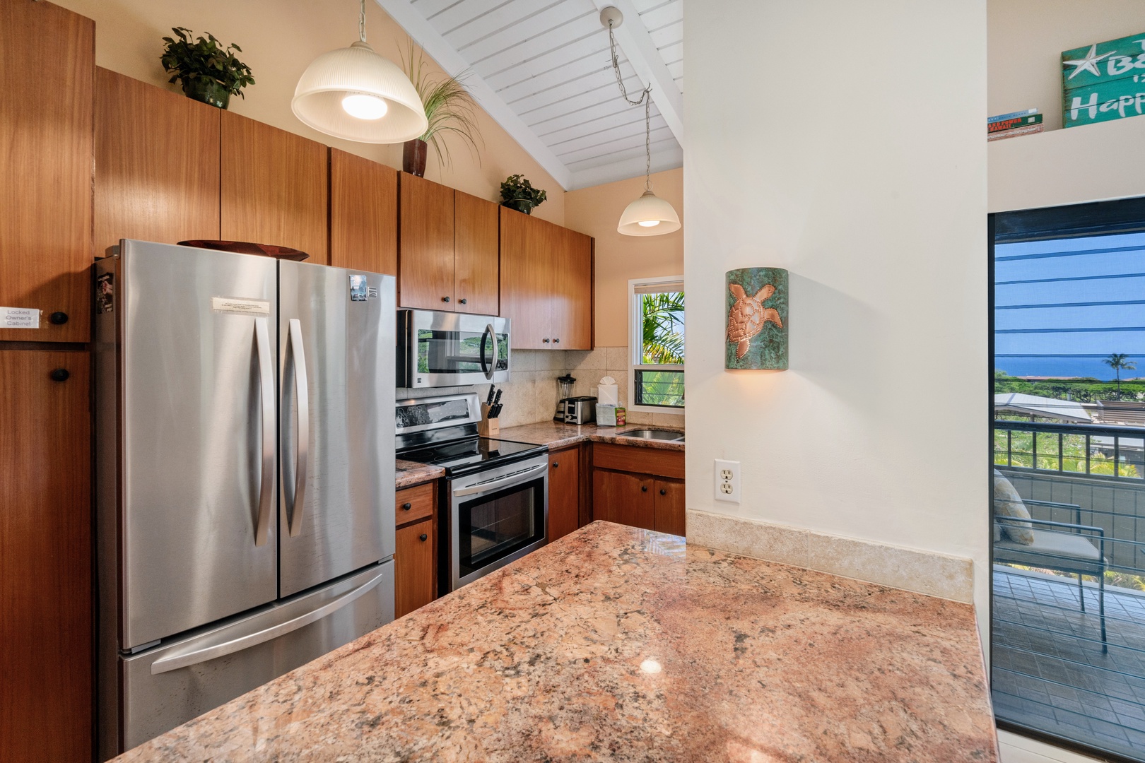 Kihei Vacation Rentals, Wailea Ekolu 204 - Wood cabinets, stone counters, and stainless appliances, set up for real cooking on vacation.