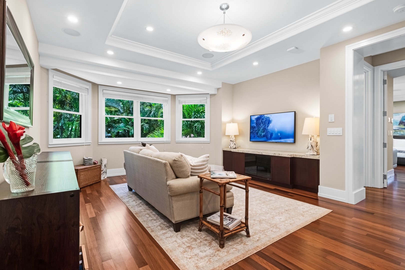 Honolulu Vacation Rentals, Pili Pono - Media lounge with sectional seating, TV, and serene windowscape.