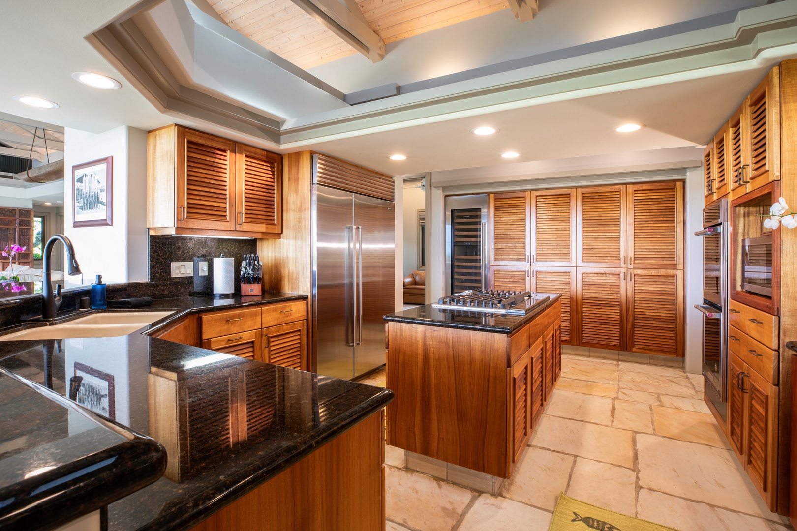 Kamuela Vacation Rentals, Canoe House at Champion Ridge - Modern kitchen with a spacious island, gas stove, and scenic views, perfect for preparing meals.
