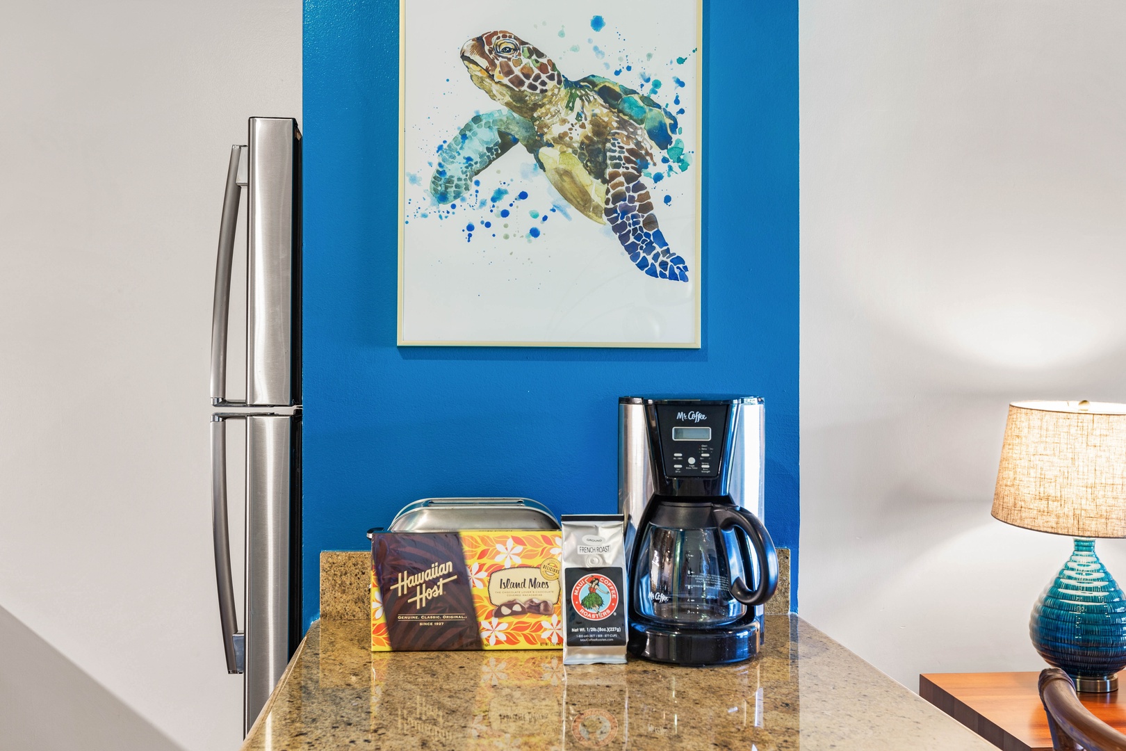 Lahaina Vacation Rentals, Napili Shores F-252 - Start your day with a freshly brewed cup of coffee in a kitchen adorned with vibrant island artwork.