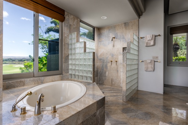 Kamuela Vacation Rentals, Canoe House & Beach Walker at Champion Ridge - Luxurious bathroom featuring a soaking tub and a spacious walk-in shower.