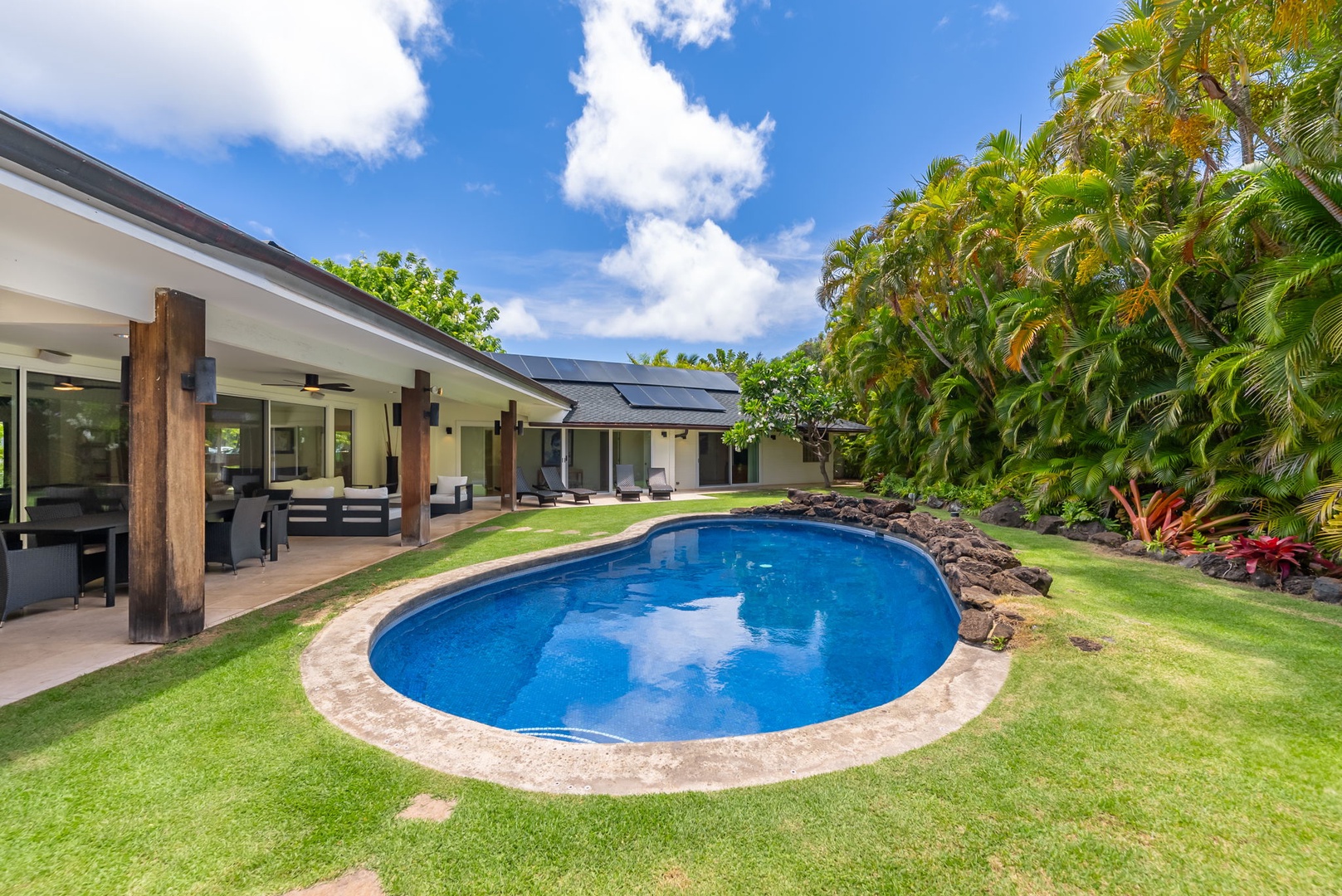 Honolulu Vacation Rentals, Kahala Lani - Sparkling oval pool surrounded by tropical greenery, the centerpiece of your stay.
