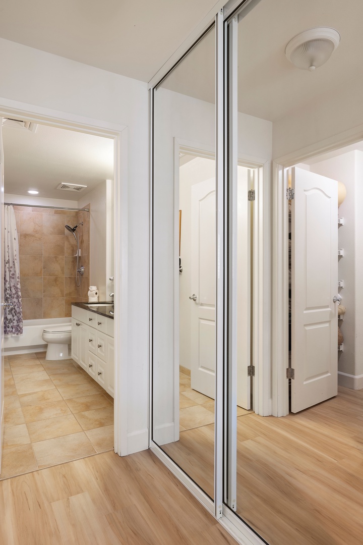 Kapolei Vacation Rentals, Ko Olina Kai 1105E - Your private en-suite bathroom features a sleek walk-in shower with warm-toned tile, ample vanity storage, and convenient mirrored closets—everything you need for a comfortable, organized stay.