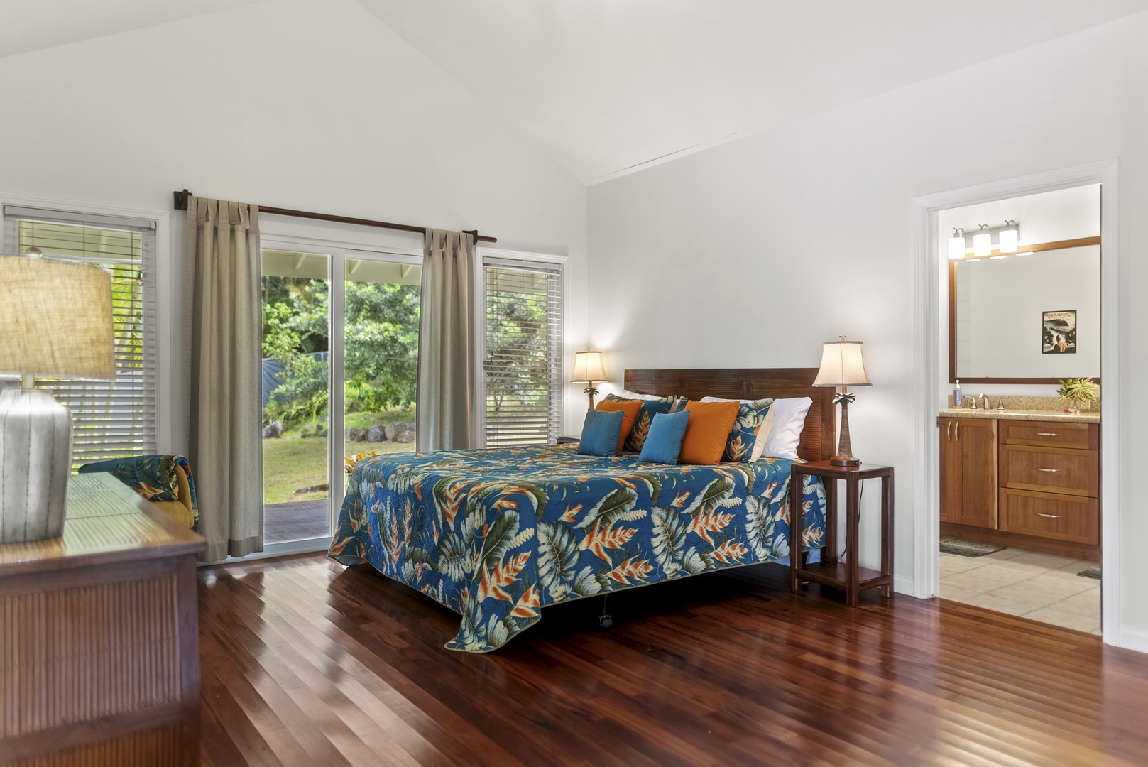 Haleiwa Vacation Rentals, North Shore Tropical Hale - Cozy primary suite with king bed, sliding glass doors to the lanai, and soft natural light filtering through the garden views.