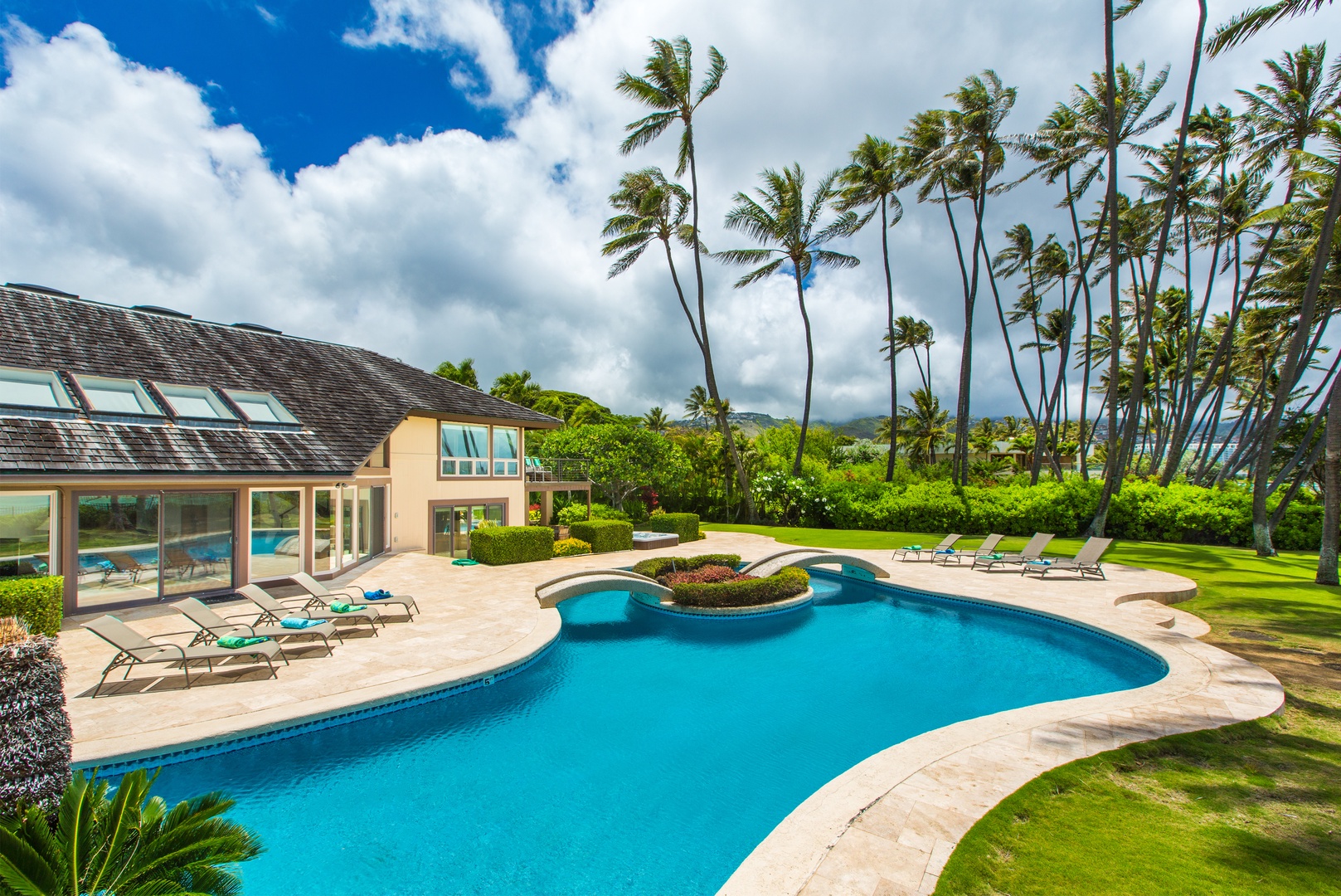 Honolulu Vacation Rentals, Kahala Mini Resort (5BR) - Blue water wraps toward the house, loungers claiming the sunniest stretch of deck.