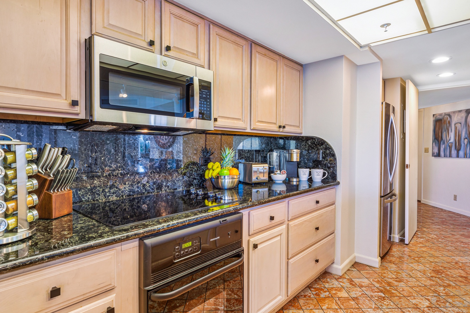 Lahaina Vacation Rentals, Kaanapali Shores 502 - The kitchen boasts granite countertops and updated appliances, perfect for preparing meals or enjoying a morning cup of coffee.