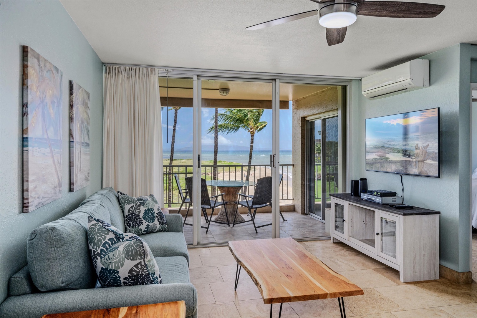 Kihei Vacation Rentals, Menehune Shores 420 - Kick back on the sofa where the open sliders frame the palms and the beach beyond.
