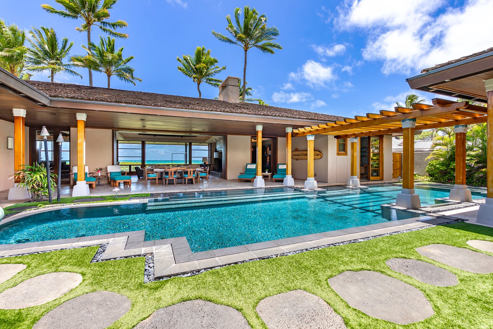 Kailua Vacation Rentals, Kailua Sands - Poolside view framed by palm trees and stone path.