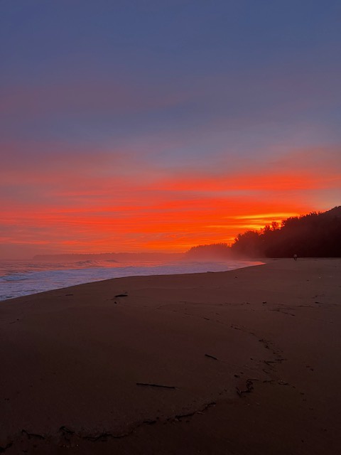 Hanalei Vacation Rentals, Hale Kepuhi - Stunning sunset paints the sky in vibrant orange and purple hues over this pristine beach coastline.