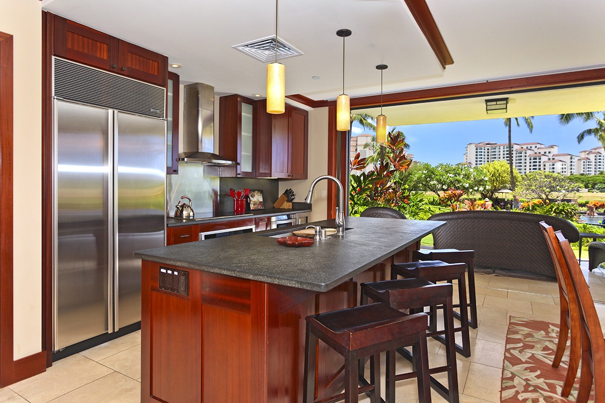 Kapolei Vacation Rentals, Ko Olina Beach Villas B103 - The Roy Yamaguci designed kitchen with views out of the sliding doors to the lanai.