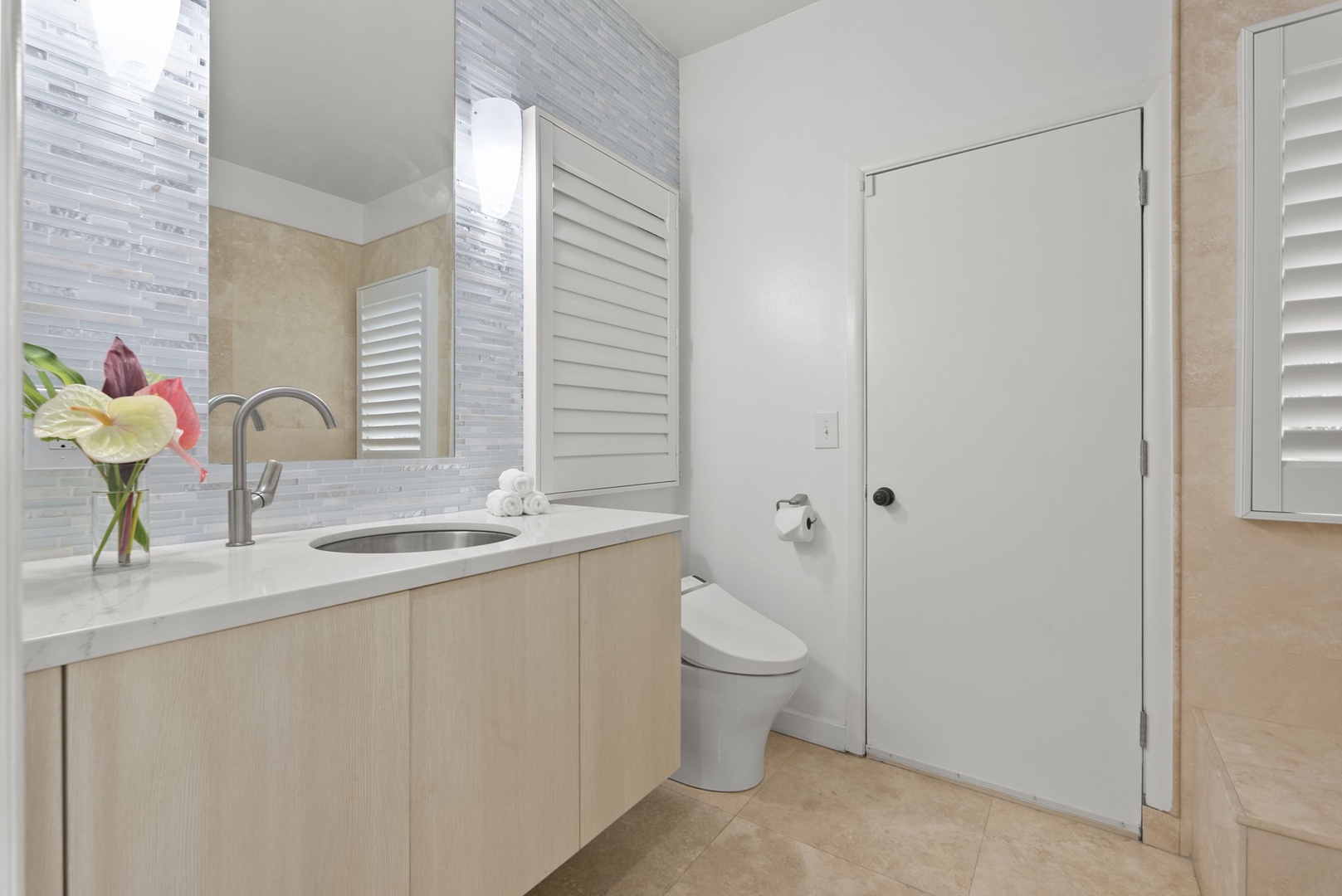 Honolulu Vacation Rentals, Paradise Beach Estate - Sleek wood cabinetry and neutral tile give this bathroom a modern, spa-like feel with easy functionality.