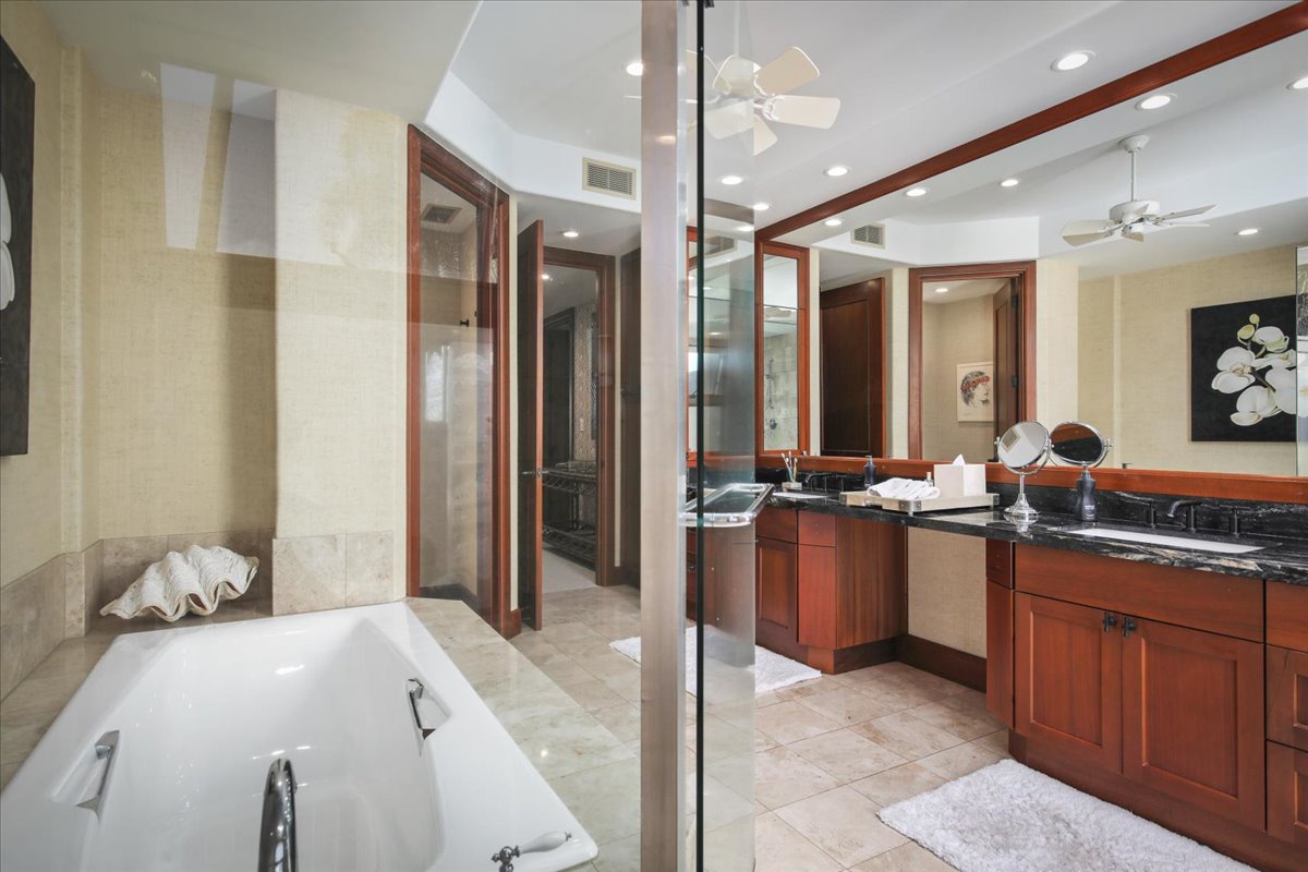 Kailua Kona Vacation Rentals, 3BD Ka'ulu Villa (129B) at Hualalai Resort - The bathroom offers a luxurious space with a soaking tub and a spacious double vanity.