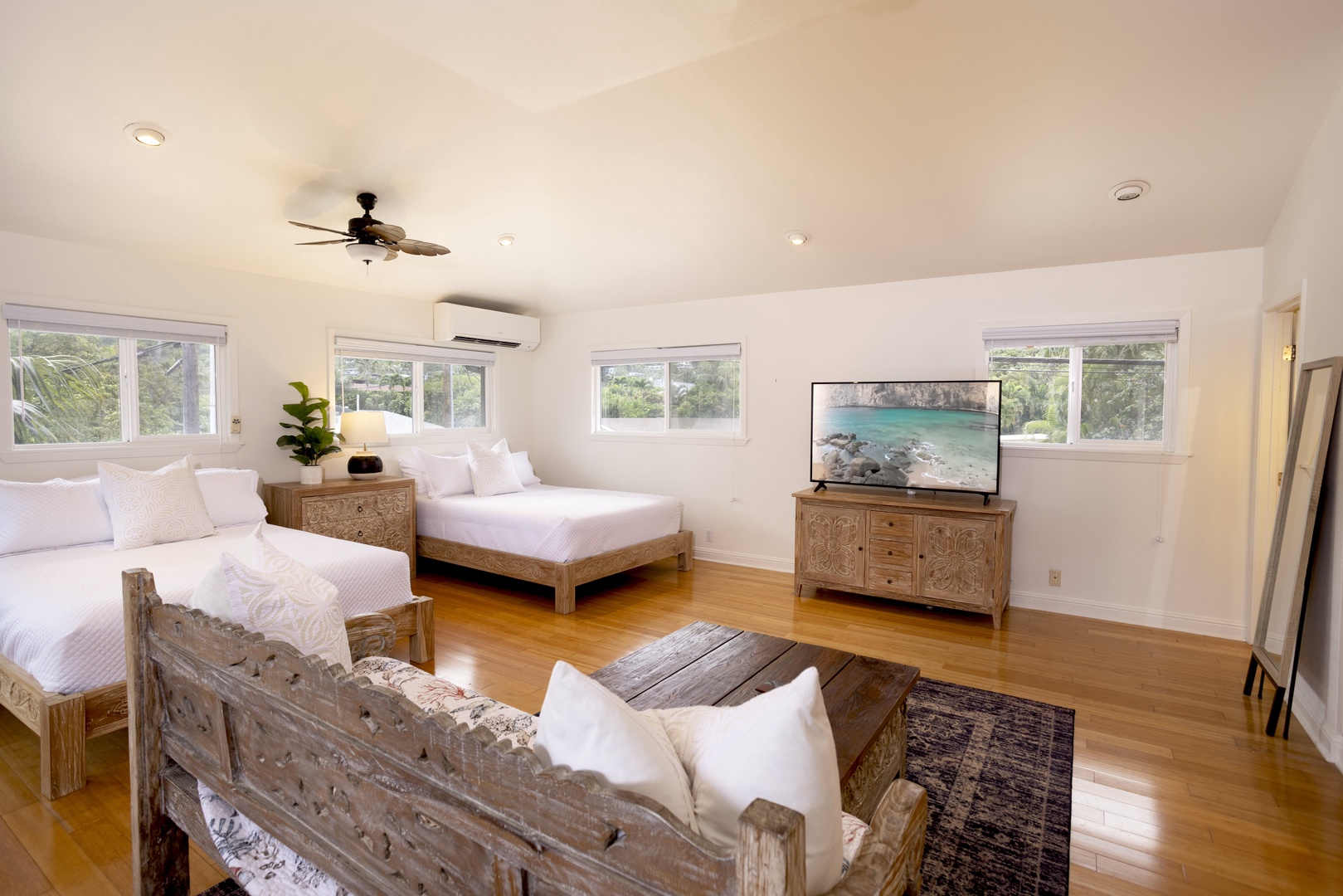 Kailua Vacation Rentals, Mokulua Seaside - Guest bedroom with two queen beds, TV and a mini lounge area, a perfect room for small family members