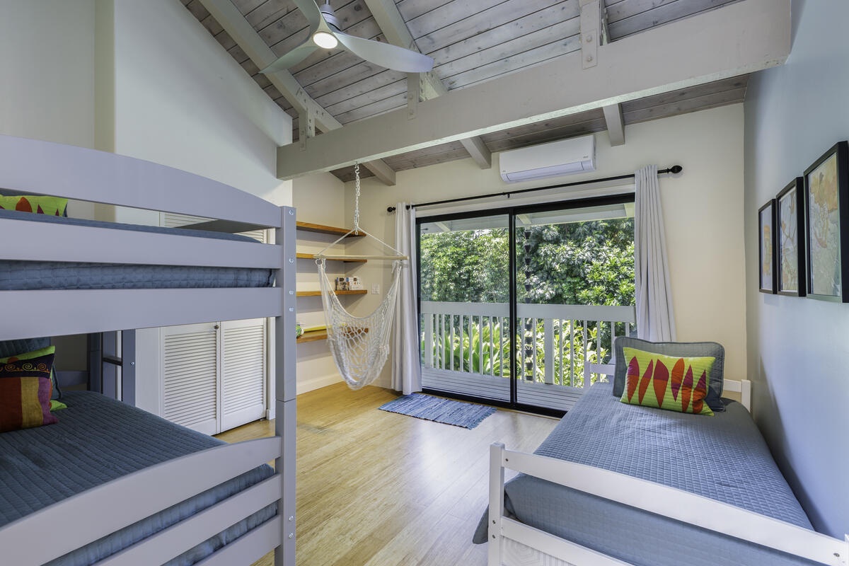 Princeville Vacation Rentals, Hale Kalani - The second bedroom houses two trundle beds, ideal for children or additional guests, while the third bedroom on the lower level boasts a King bed and en suite, complete with direct access to the garden