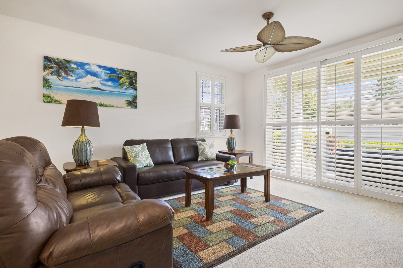 Natural light, plantation shutters, and comfortable furnishings make this a welcoming spot for morning coffee or a quiet evening indoors.
