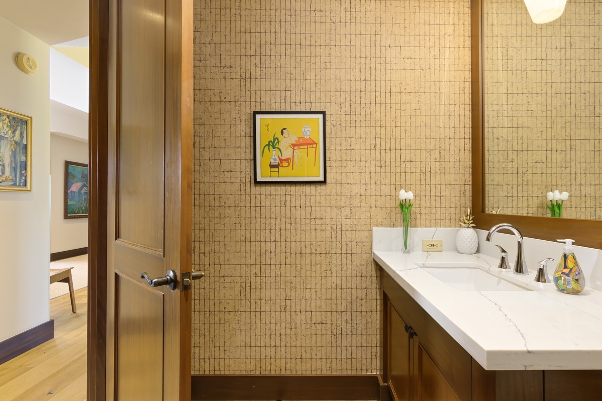 Kailua Kona Vacation Rentals, Fairways Villa 120A - Step into this elegant bathroom with stunning mosaic tile walls and marble vanity, where fresh tulips create a welcoming touch for your stay.