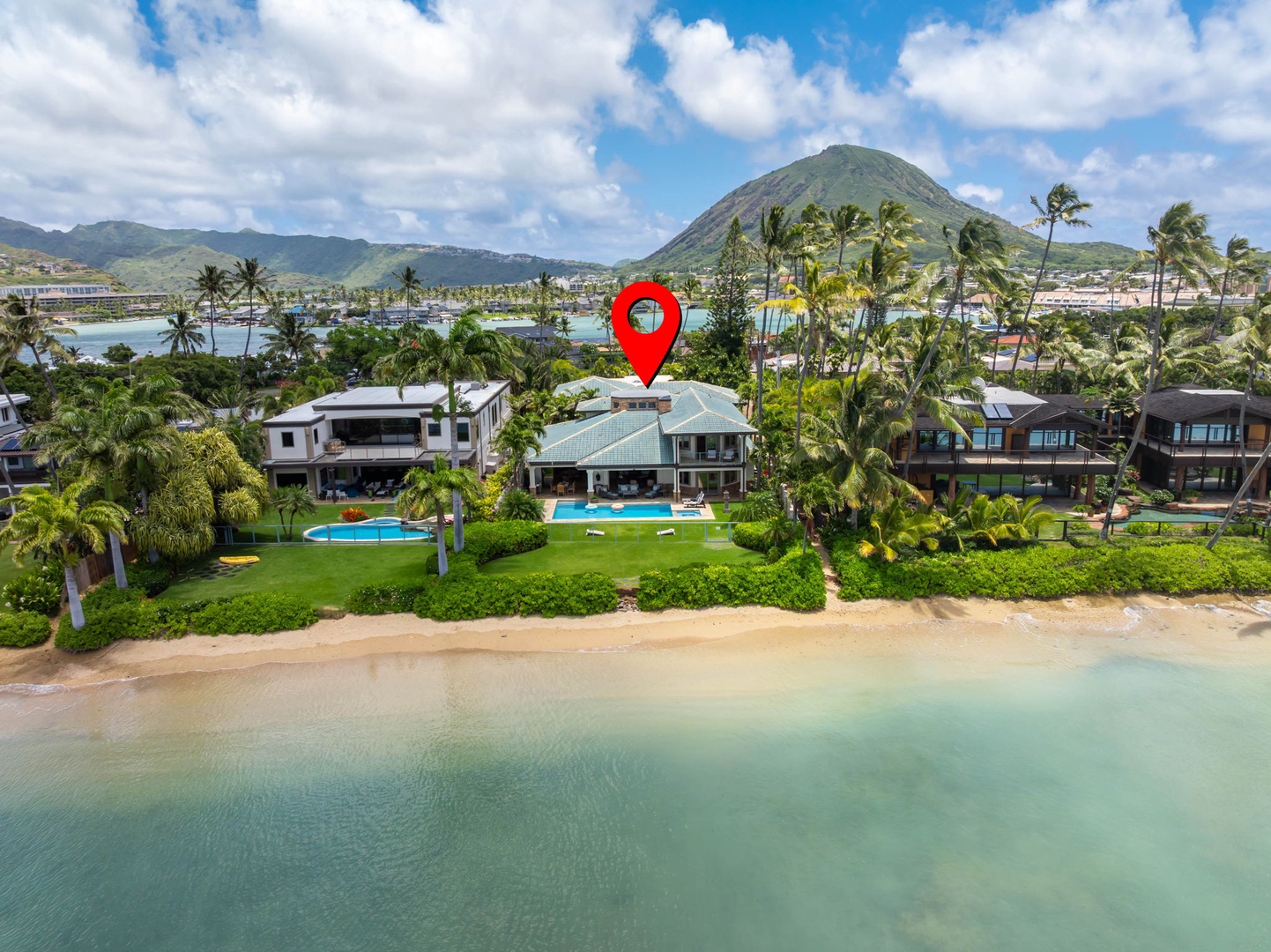 Honolulu Vacation Rentals, Maunalua Estate - Aerial views showcase the home's rare stretch of sandy beachfront and calm blue waters.