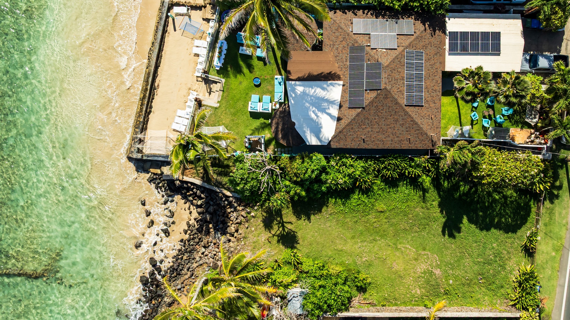 Hauula Vacation Rentals, Private Beach Paradise - Stunning aerial view of a beachfront property with tropical gardens and private outdoor spaces.