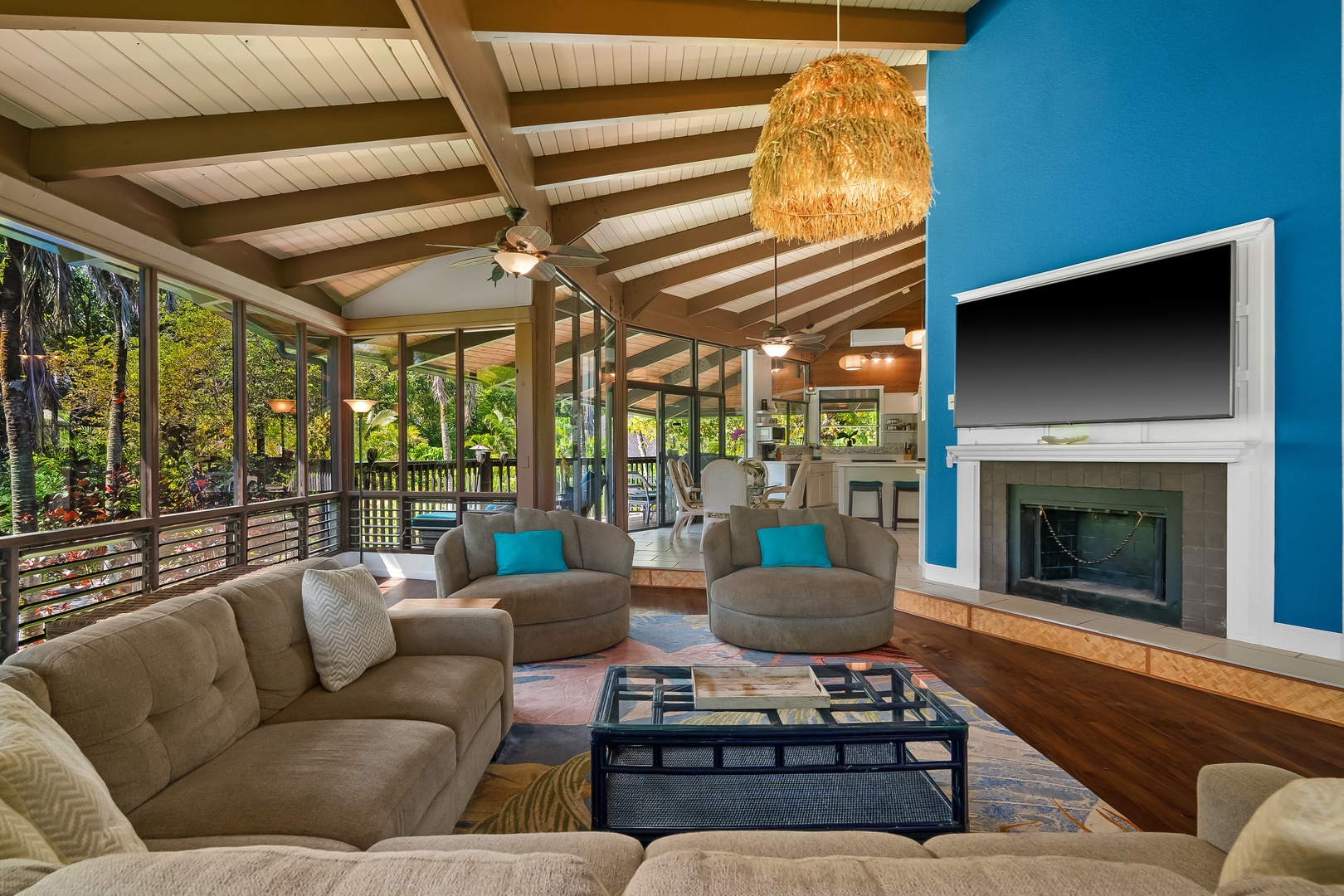 Princeville Vacation Rentals, Mauna Kai 7B - Windows wrap the living room, so the green outside never quite leaves the room.
