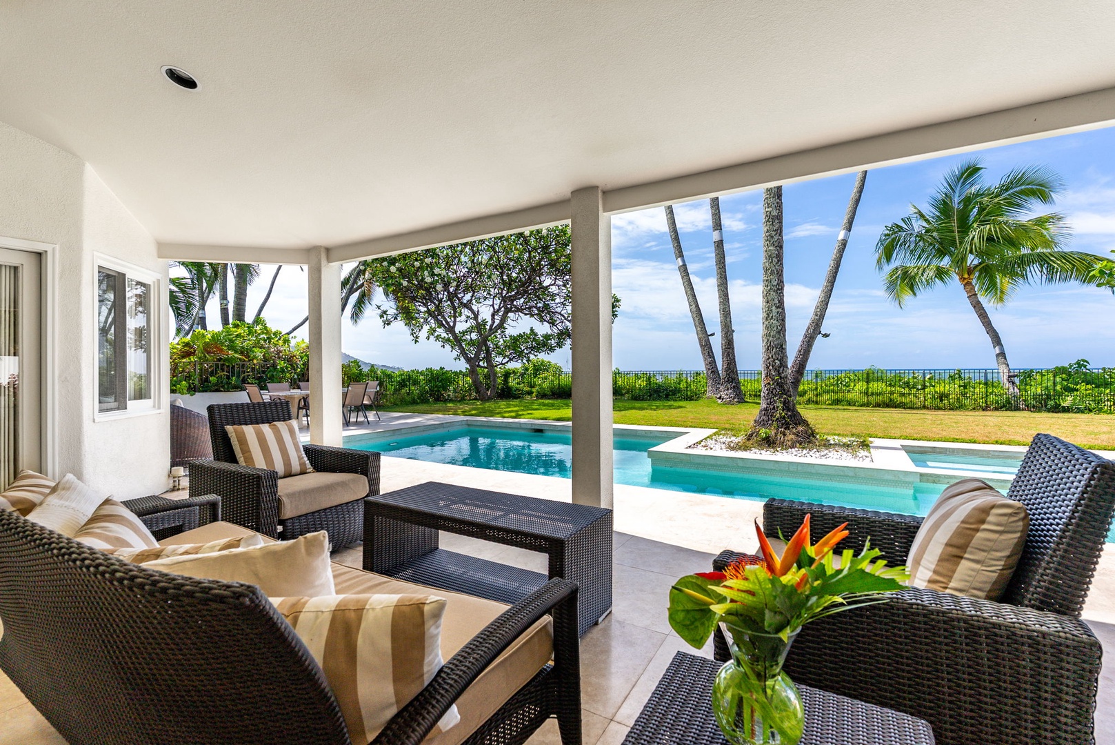 Honolulu Vacation Rentals, Paradise Beach Estate - Gather beneath the shaded lanai for drinks or morning coffee—set against panoramic views of the Pacific and swaying palms.