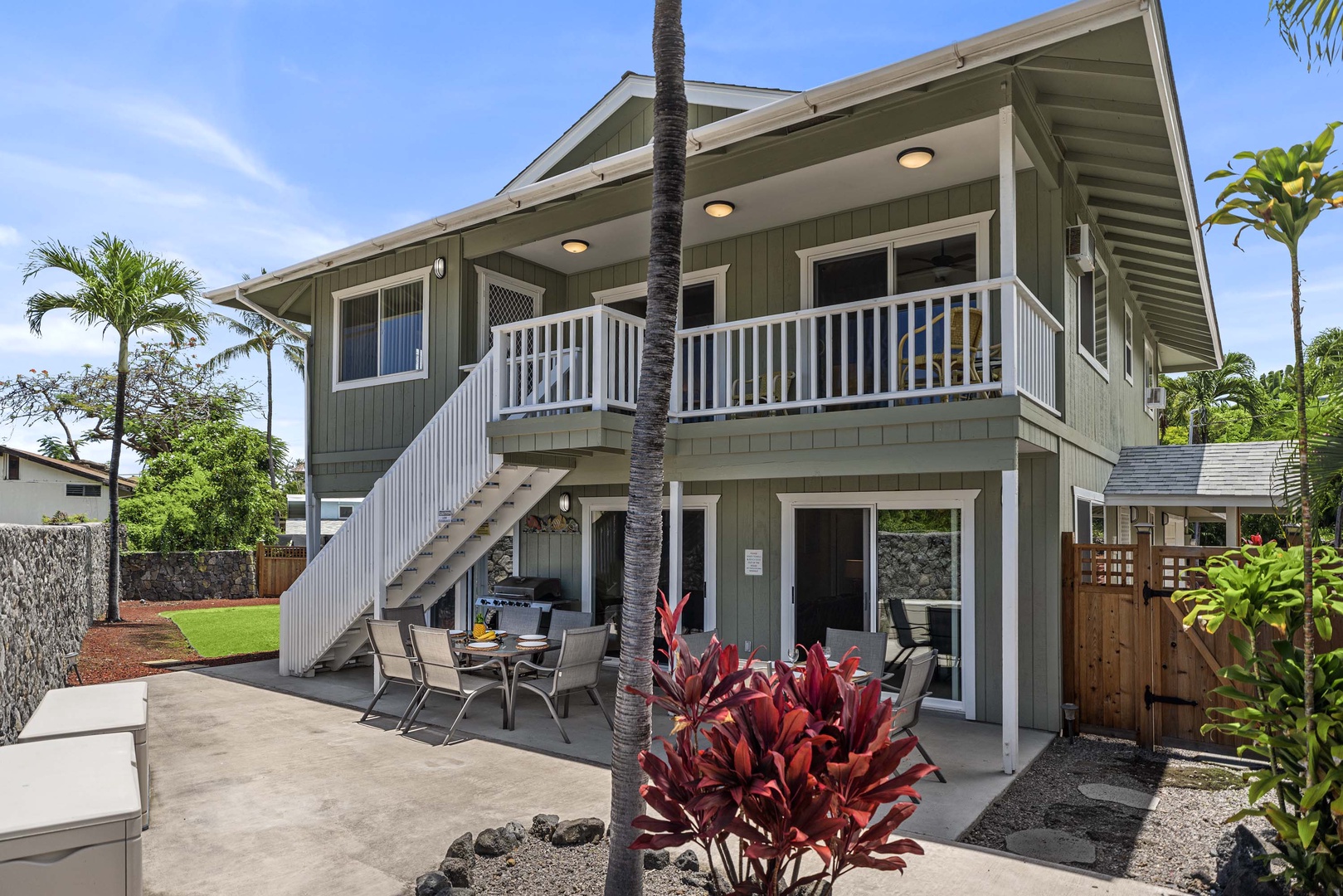 Kailua Kona Vacation Rentals, Hale A Kai - Facing the side of the home showcasing the seating and stairs to the upstairs space