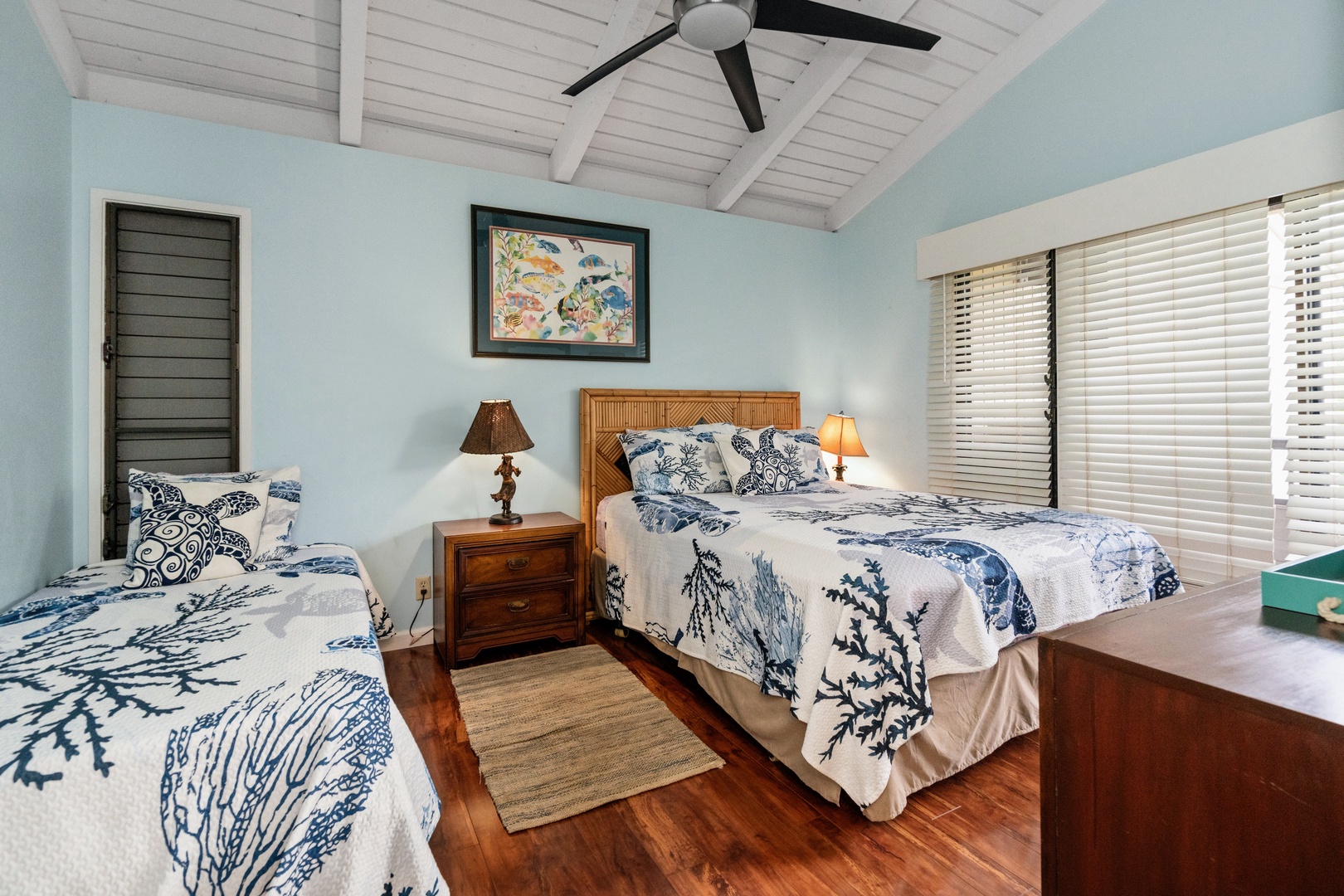 Kihei Vacation Rentals, Wailea Ekolu 204 - The second bedroom pairs a queen with a twin, both dressed in matching turtle-and-coral quilts beneath a vaulted, beamed ceiling.