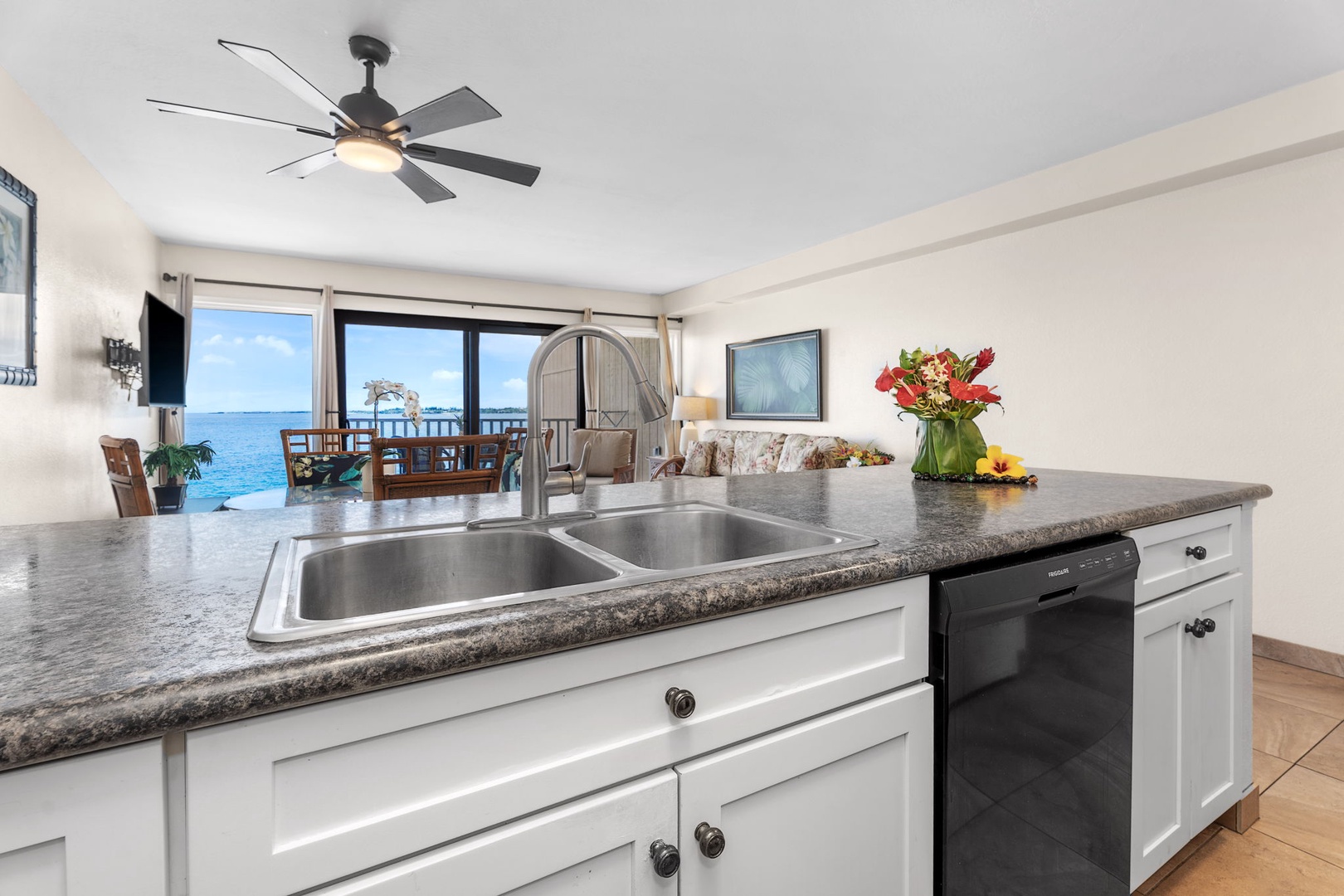 Kailua Kona Vacation Rentals, Sea Village 4213 - Ocean view reflections from the kitchen—granite counters, bar seating, and tropical breezes just steps away.
