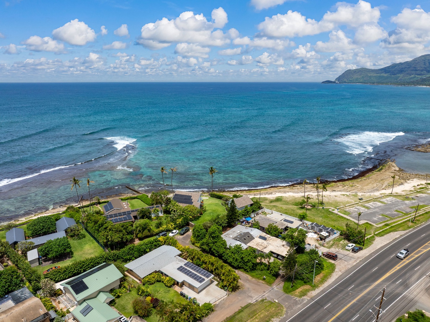 Waianae Vacation Rentals, Ma'ili Blue - Stunning oceanfront location with turquoise waters and dramatic mountain coastline creating the perfect tropical getaway backdrop.