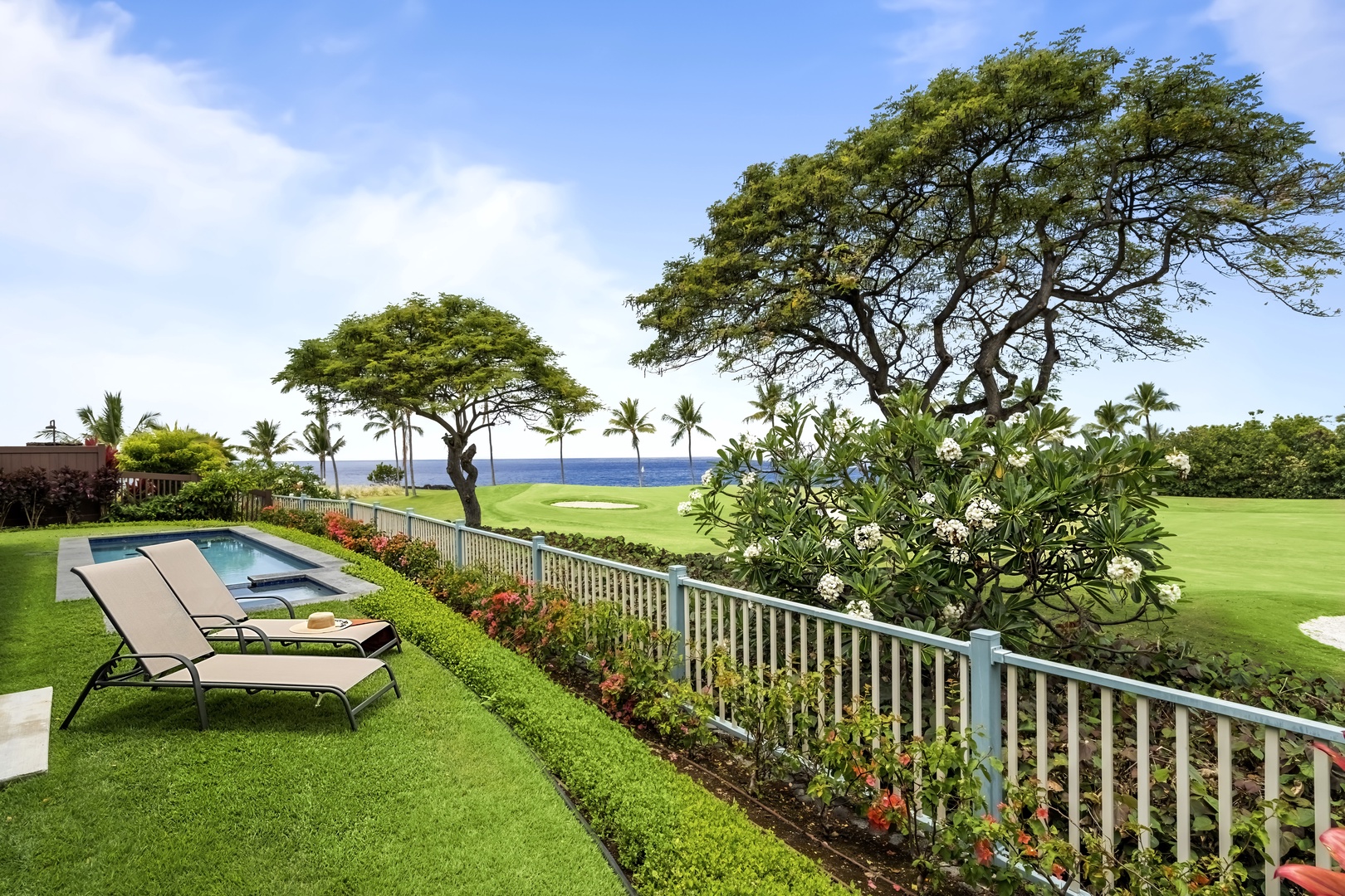 Kailua Kona Vacation Rentals, Holua Kai #27 - Grab the shade of the monkeypod, loungers out and the fairway just past the fence.