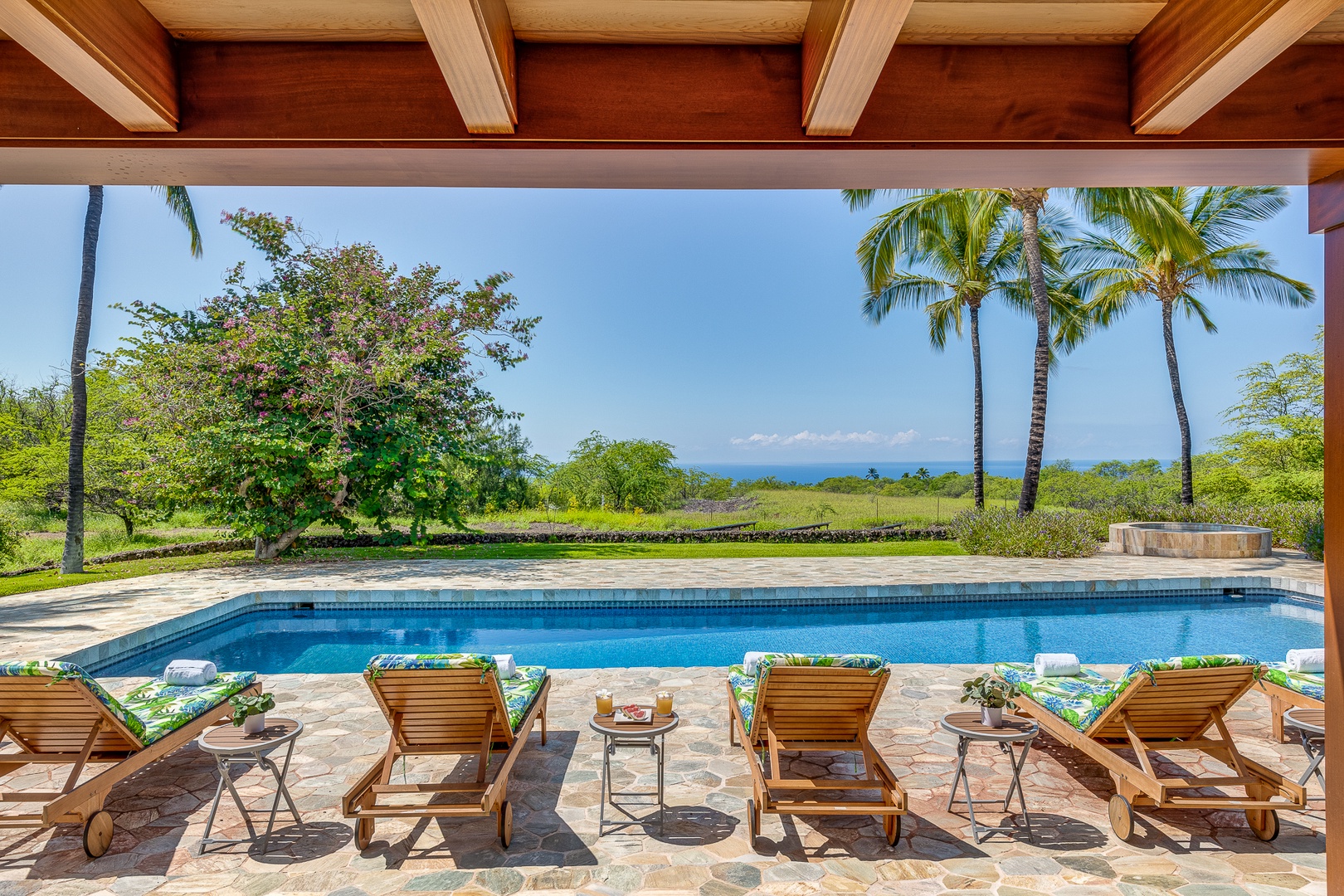 Kamuela Vacation Rentals, Olomana Hale at Kohala Ranch - The massive pool deck offers lots of options for lounging and outdoor dining for up to 12 people seated at two tables: one for eight and another for four with direct ocean views and sunset
