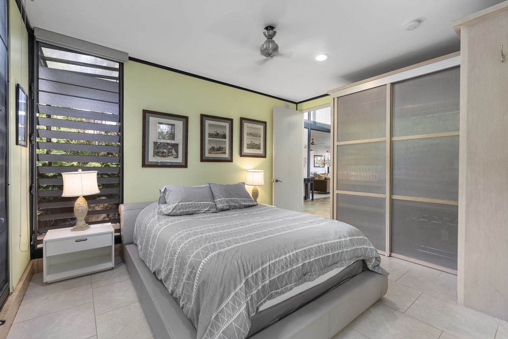 Honolulu Vacation Rentals, Tantalus Glass House (3 BD) - Drift off in this peaceful bedroom with comfortable bedding, elegant artwork, and calming green walls that create your perfect retreat.
