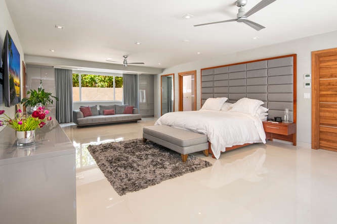 Honolulu Vacation Rentals, Diamond Head Beachfront Estate - Main-level asian king suite with soft lighting, luxe bedding, and easy outdoor access.
